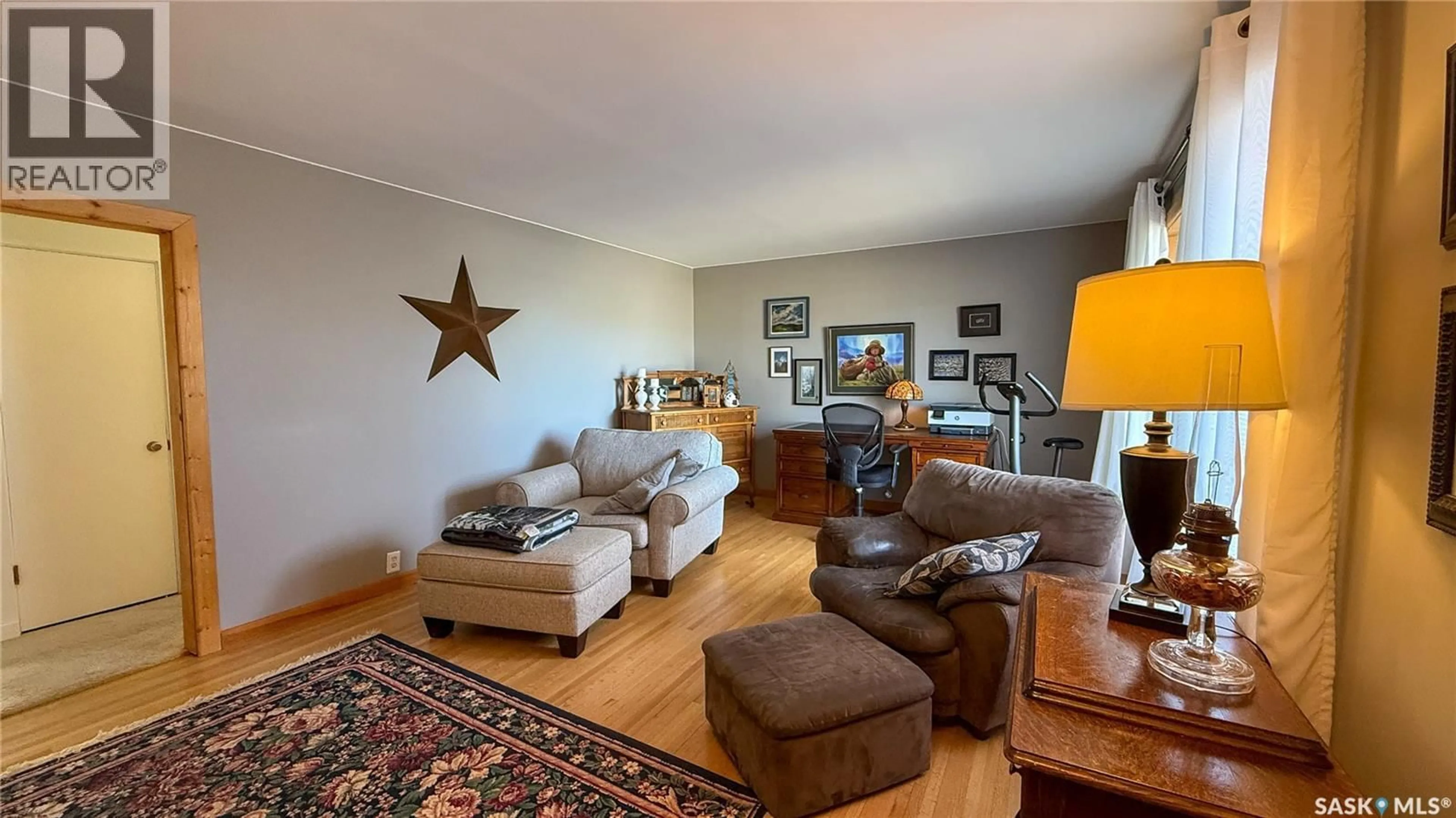 Living room with furniture, wood/laminate floor for 1752 93RD STREET, North Battleford Saskatchewan S9A0C8