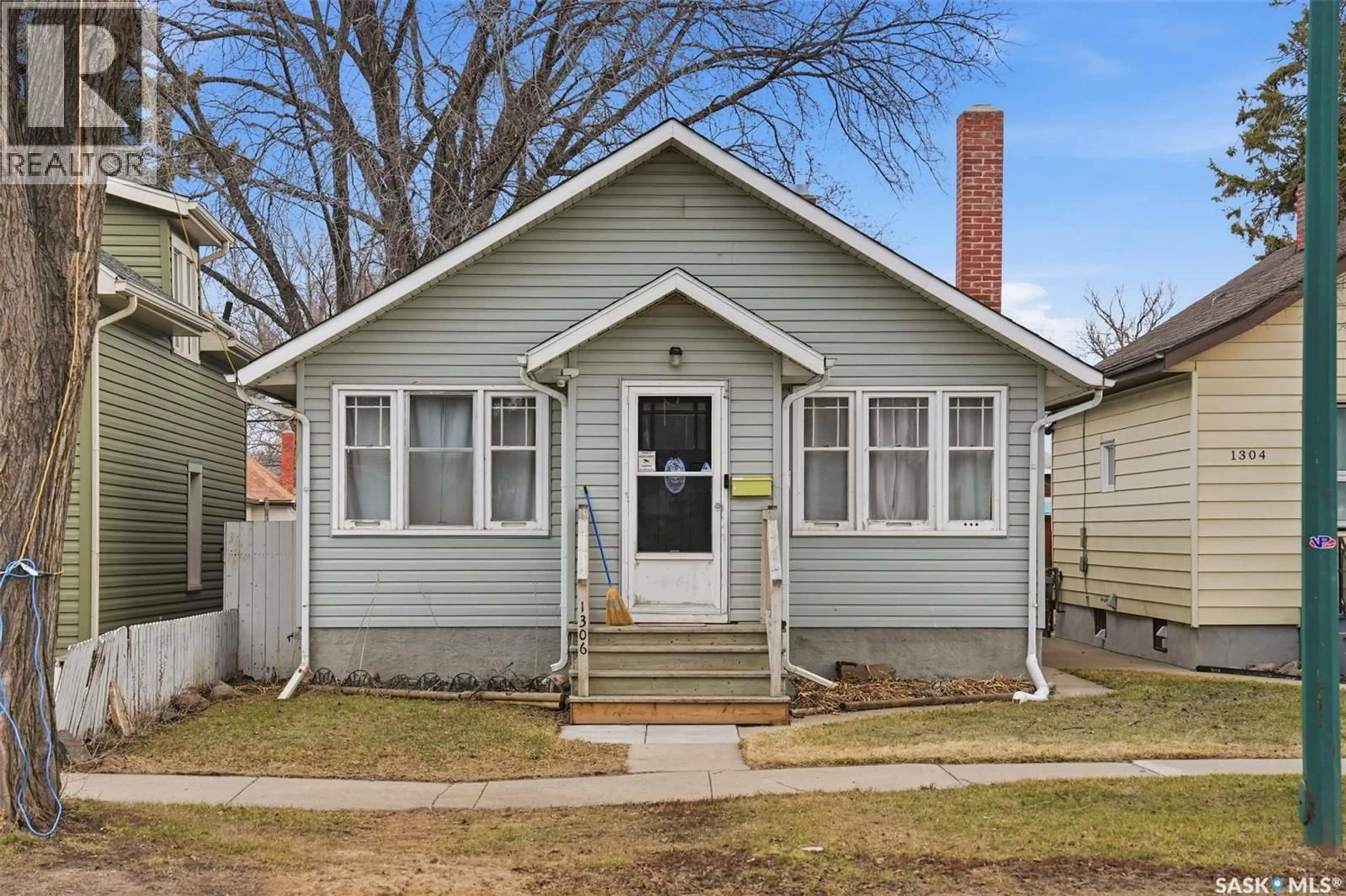 Home with vinyl exterior material, street for 1306 C AVENUE, Saskatoon Saskatchewan S7L1K8