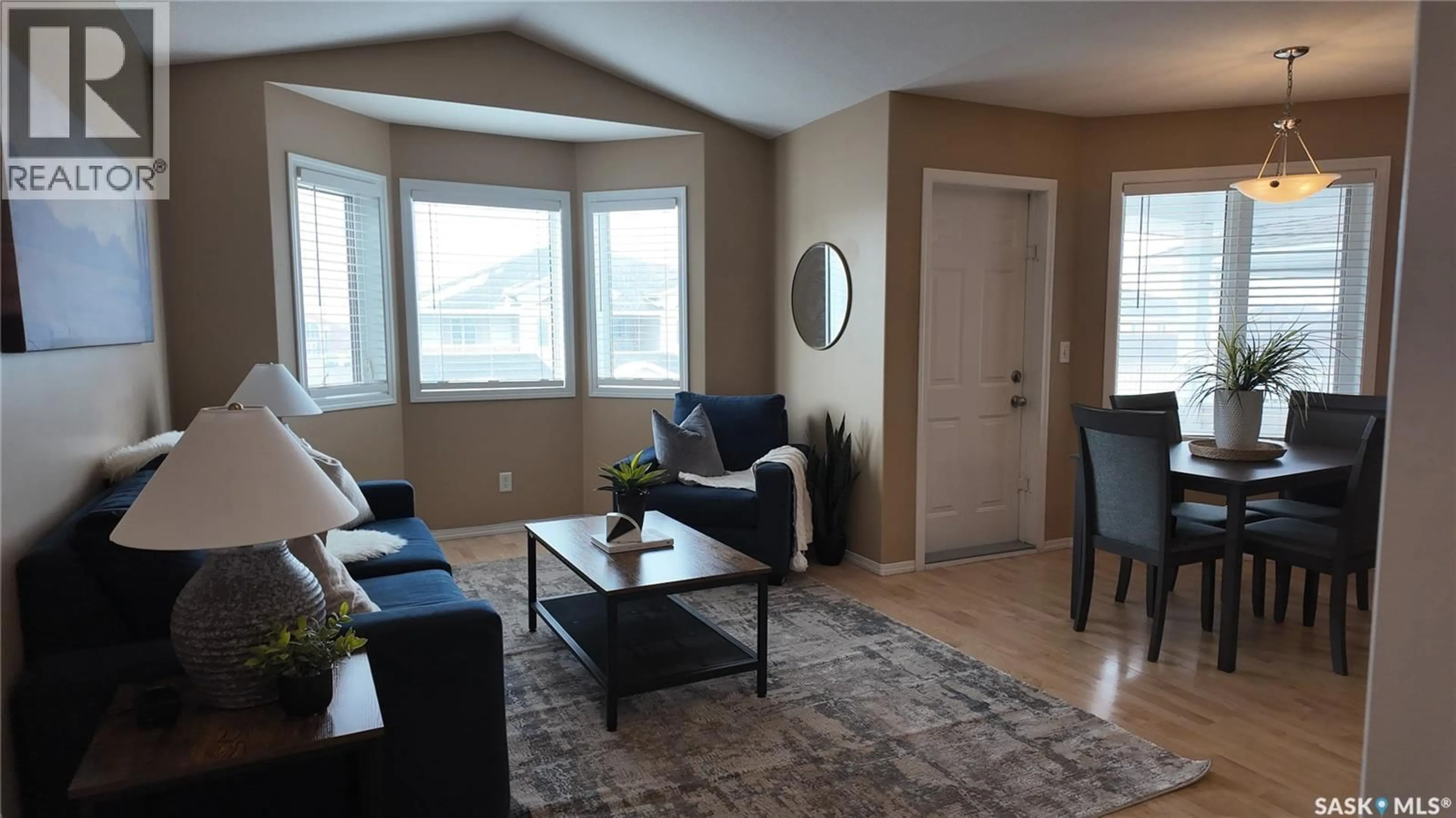 Living room with furniture, wood/laminate floor for E - 4128 BUCKINGHAM DRIVE, Regina Saskatchewan S4V3A9