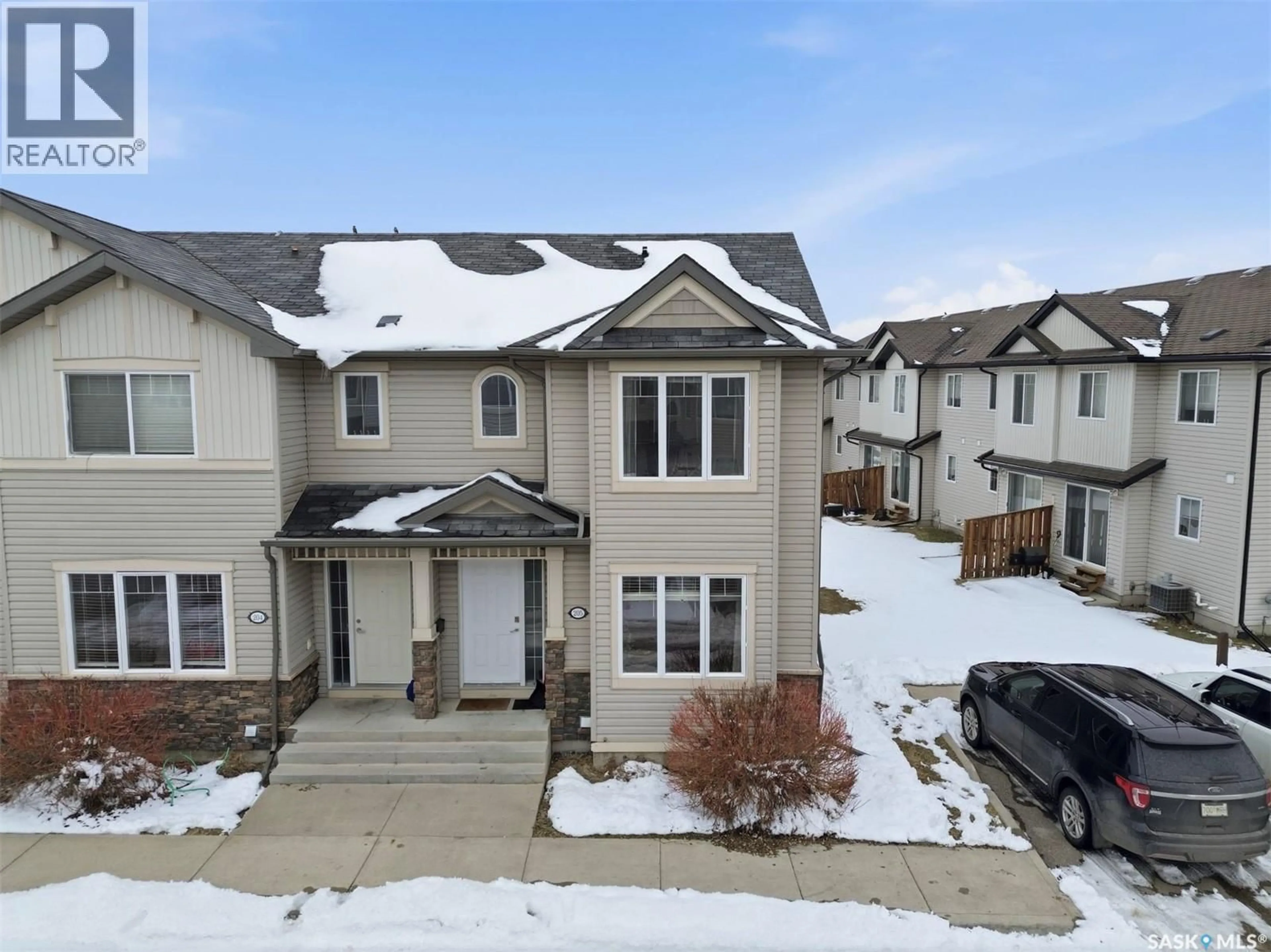 A pic from outside/outdoor area/front of a property/back of a property/a pic from drone, street for 205 - 303 SLIMMON PLACE, Saskatoon Saskatchewan S7V0A8
