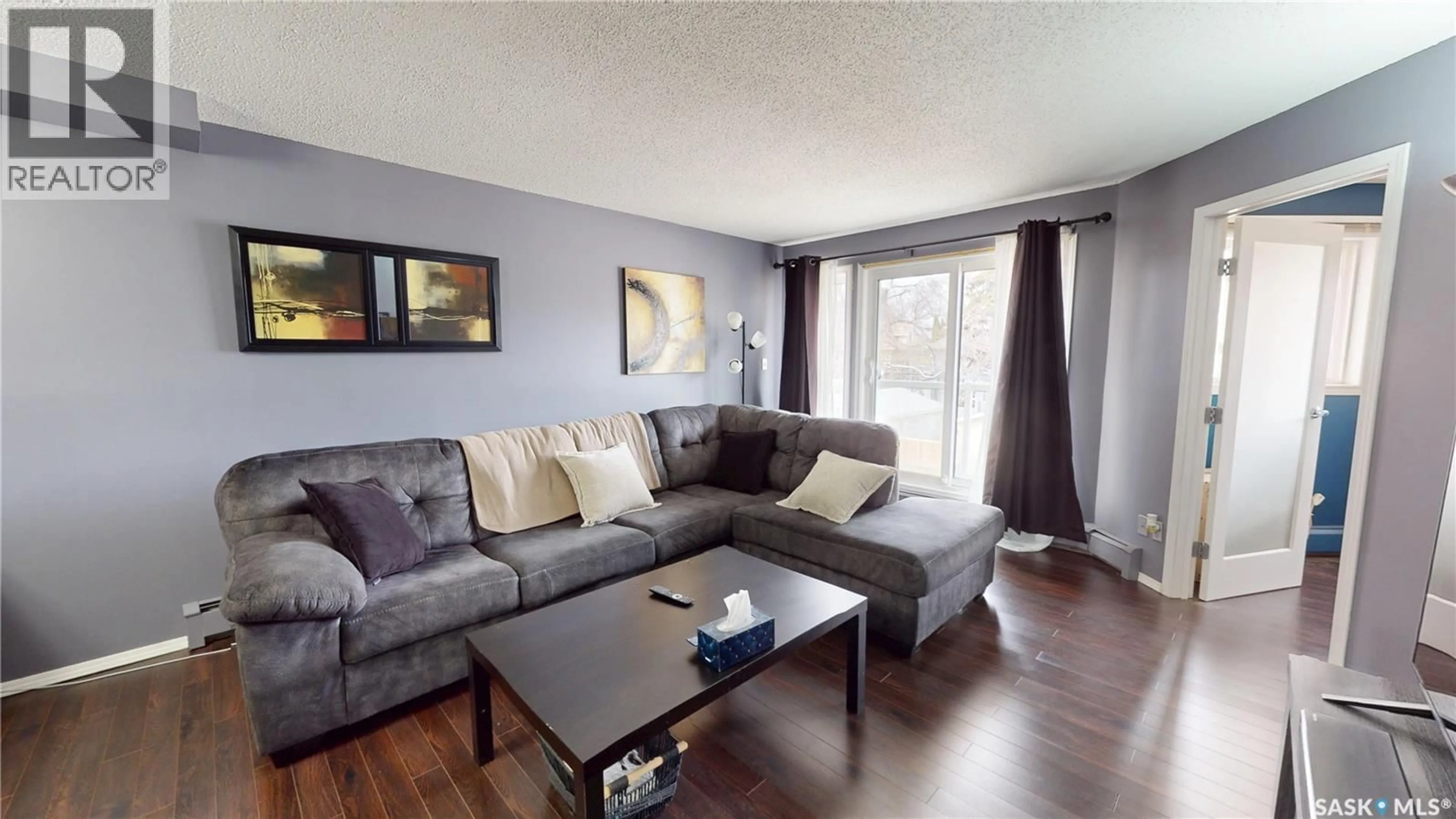 Living room with furniture, wood/laminate floor for 203 - 921 MAIN STREET, Saskatoon Saskatchewan S7H0K4