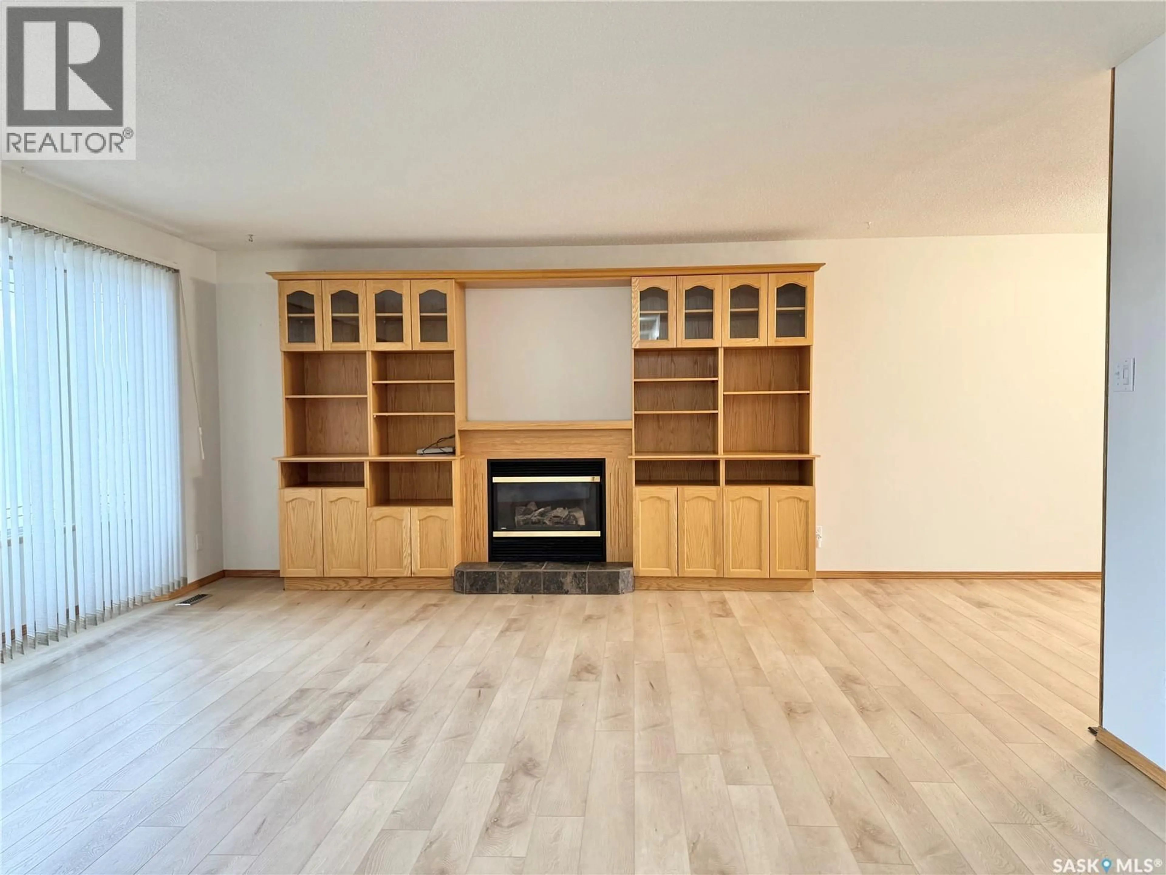 Living room with furniture, wood/laminate floor for 521 HEARN STREET, Outlook Saskatchewan S0L2N0
