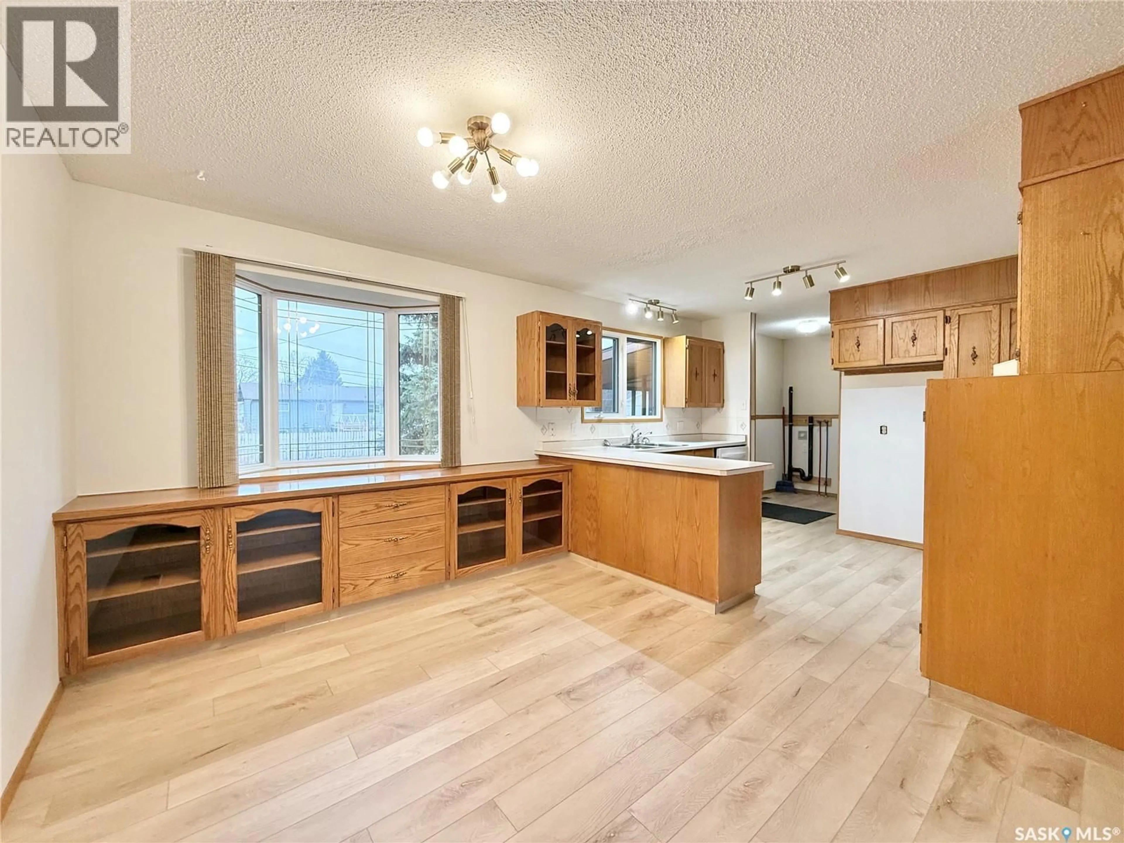 Open concept kitchen, wood/laminate floor for 521 HEARN STREET, Outlook Saskatchewan S0L2N0
