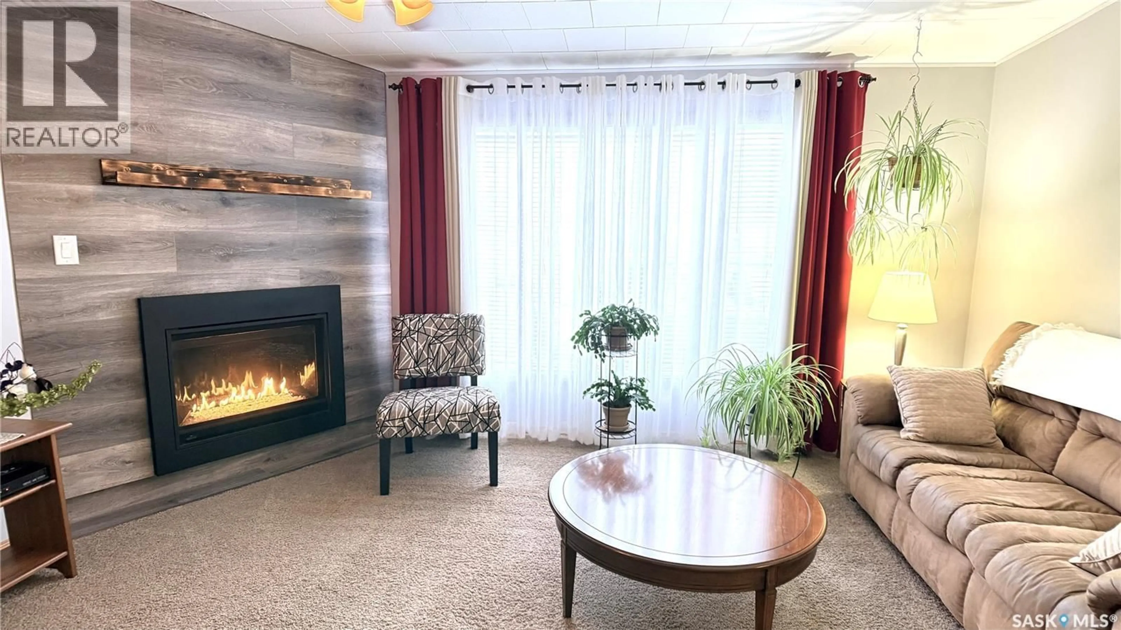 Living room with furniture, wood/laminate floor for 41 ROYAL HEIGHTS, Estevan Saskatchewan S4A2T9