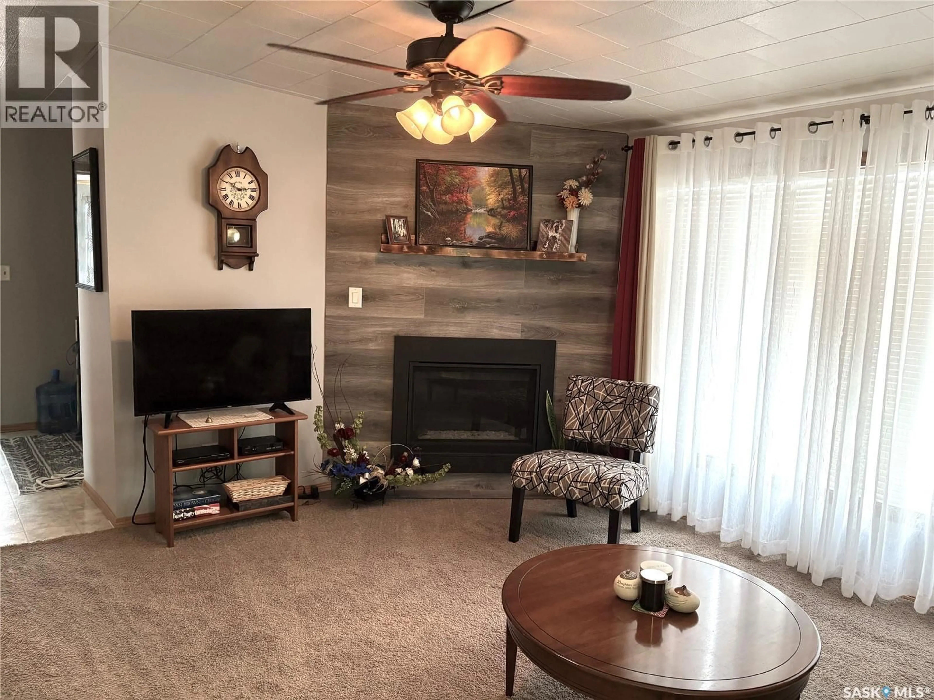Living room with furniture, wood/laminate floor for 41 ROYAL HEIGHTS, Estevan Saskatchewan S4A2T9
