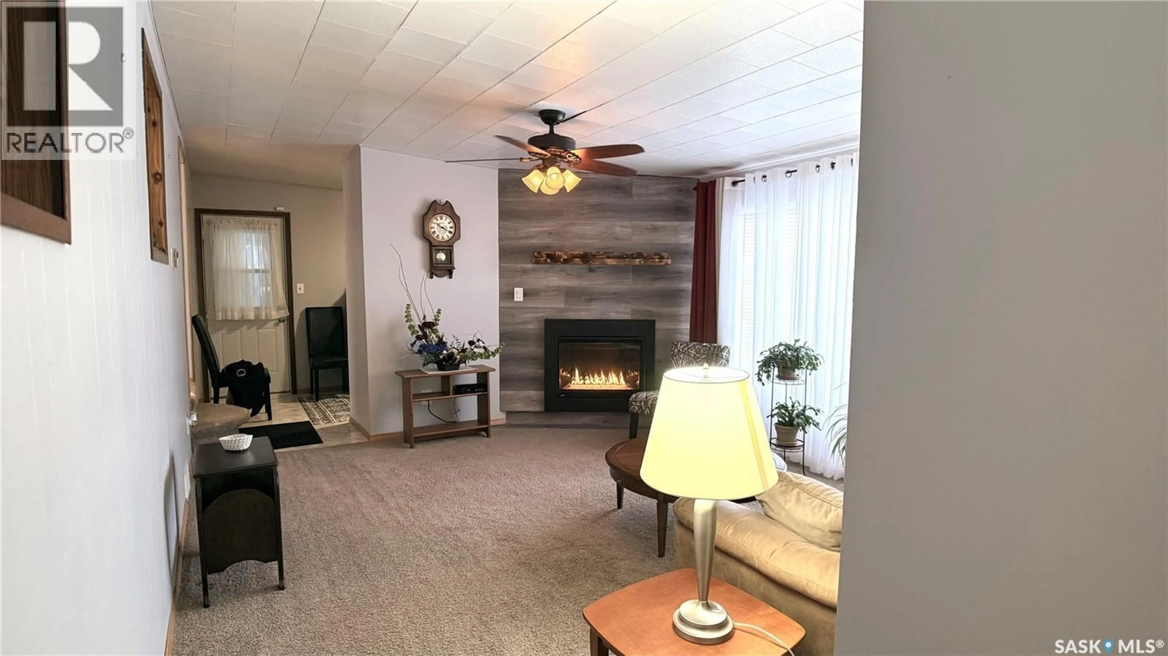 Living room with furniture, wood/laminate floor for 41 ROYAL HEIGHTS, Estevan Saskatchewan S4A2T9