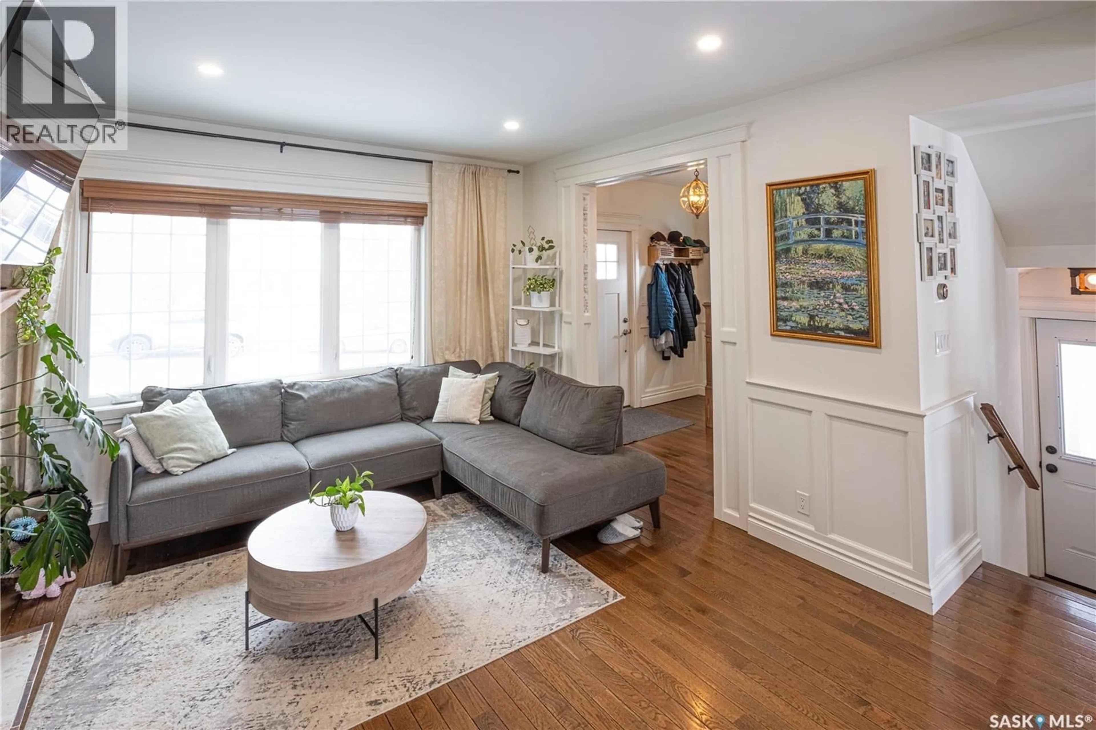 Living room with furniture, wood/laminate floor for 832 ALGOMA AVENUE, Moose Jaw Saskatchewan S6H3Z3