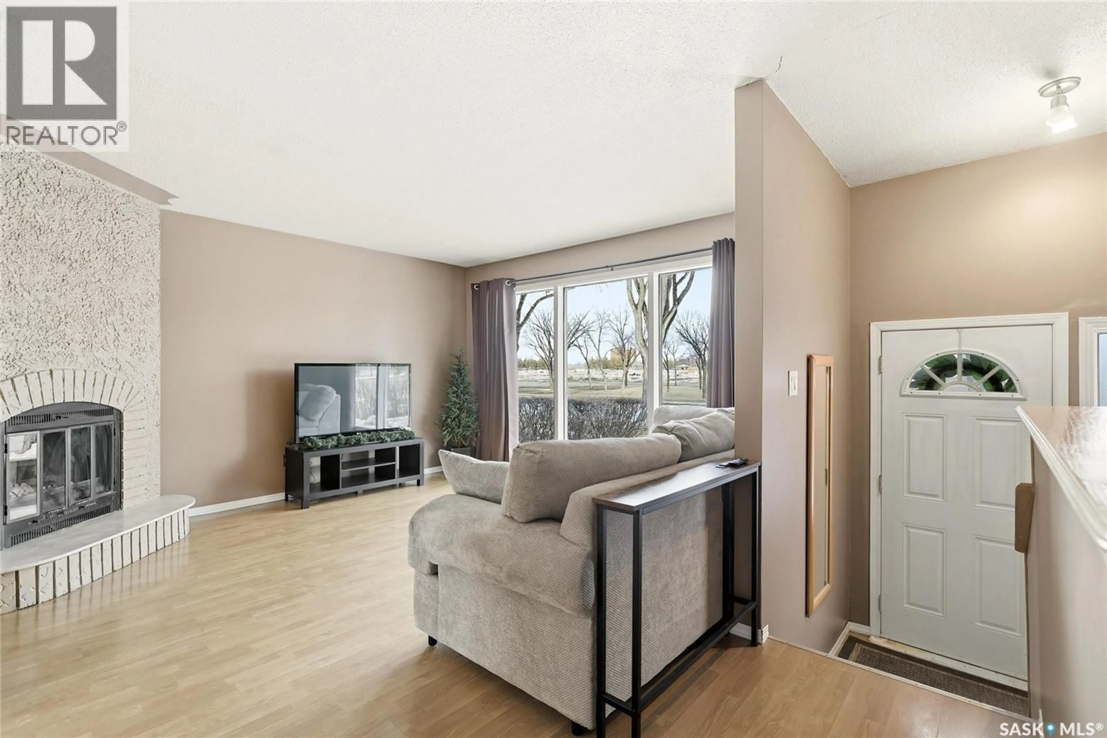 Living room with furniture, wood/laminate floor for 3312 GRANT ROAD, Regina Saskatchewan S4S5H5