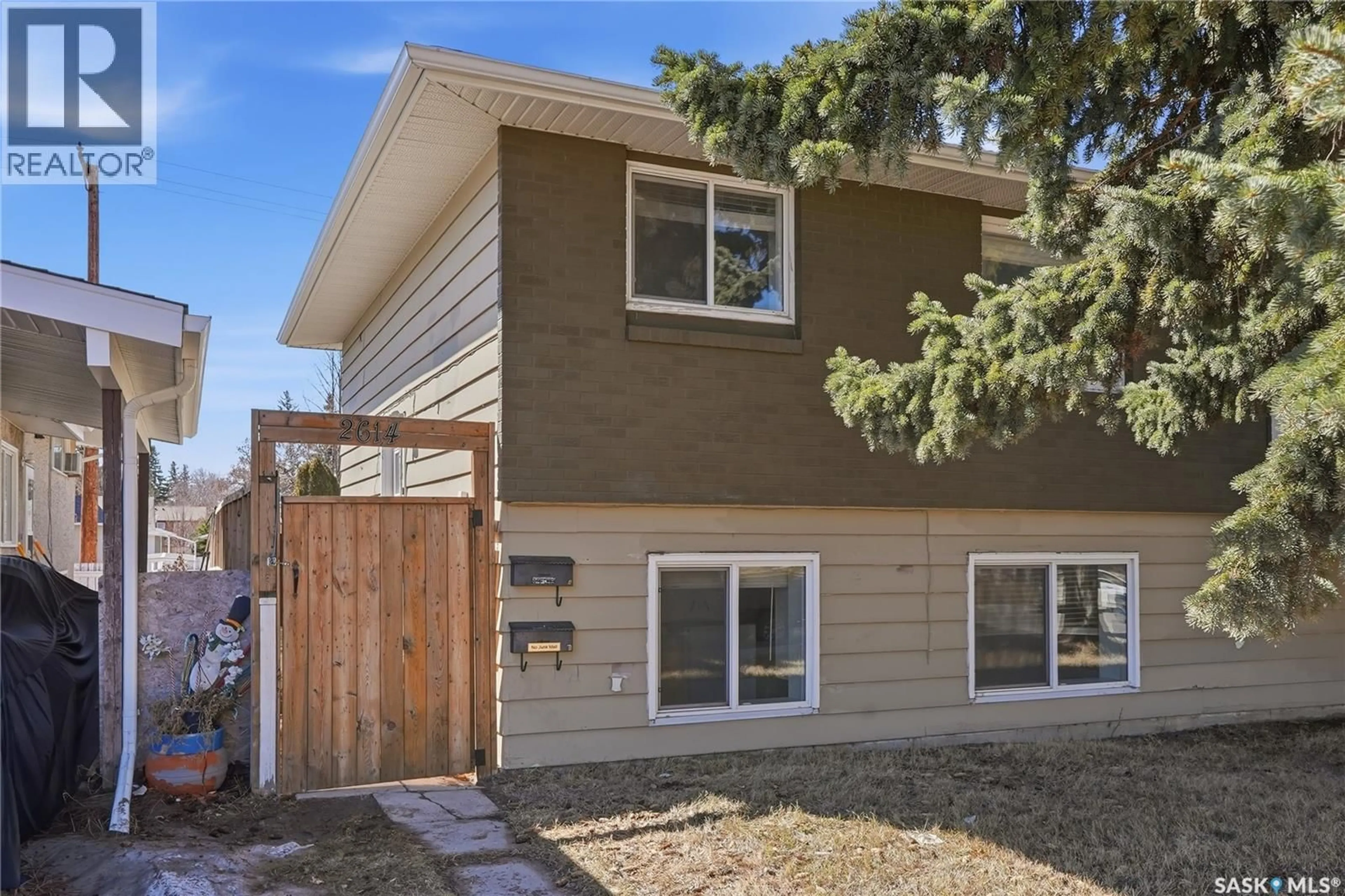 Home with vinyl exterior material, street for 2614 7TH STREET, Saskatoon Saskatchewan S7H1A5