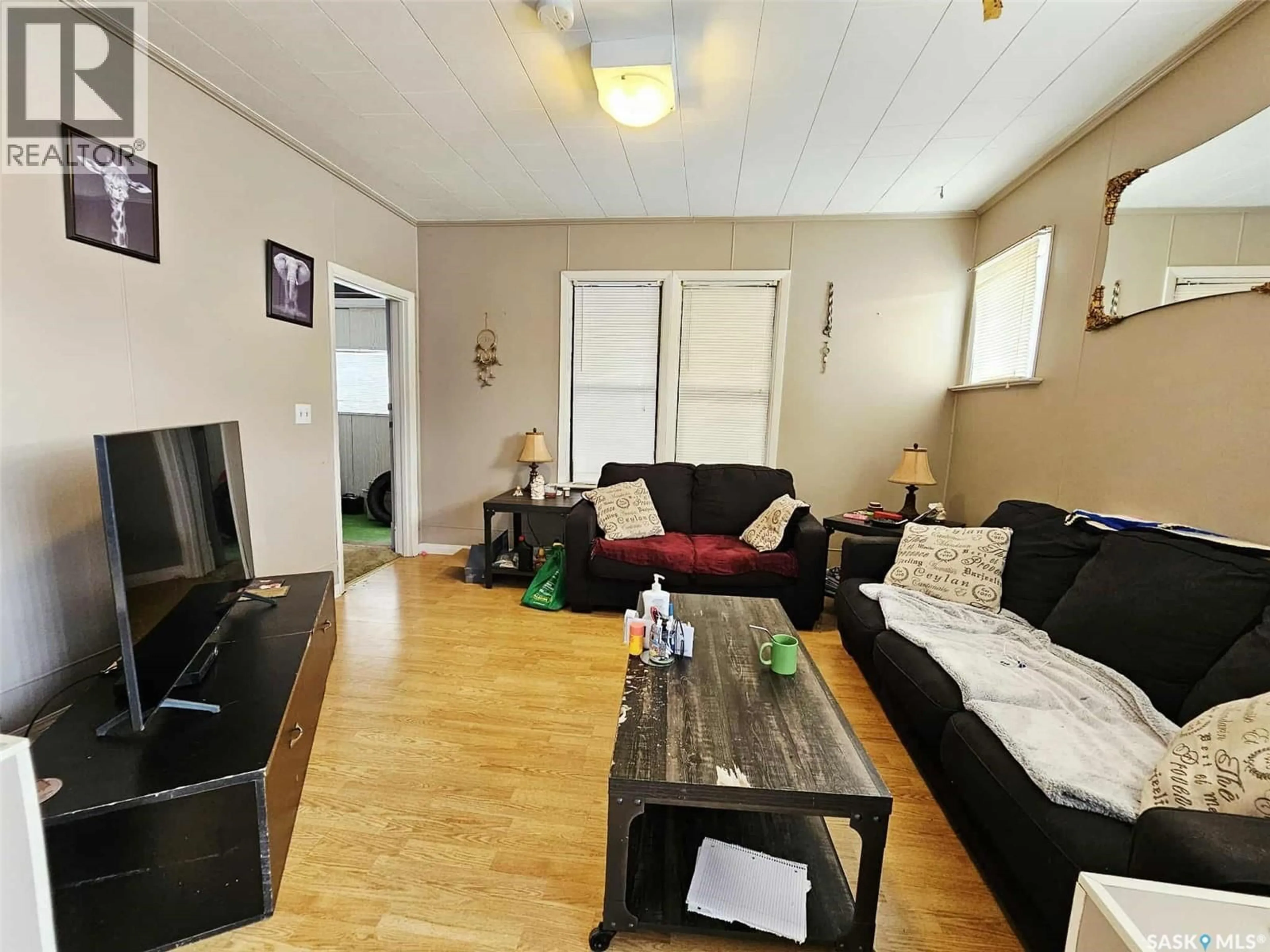 Living room with furniture, wood/laminate floor for 25 BECK STREET, Dubuc Saskatchewan S0A0R0