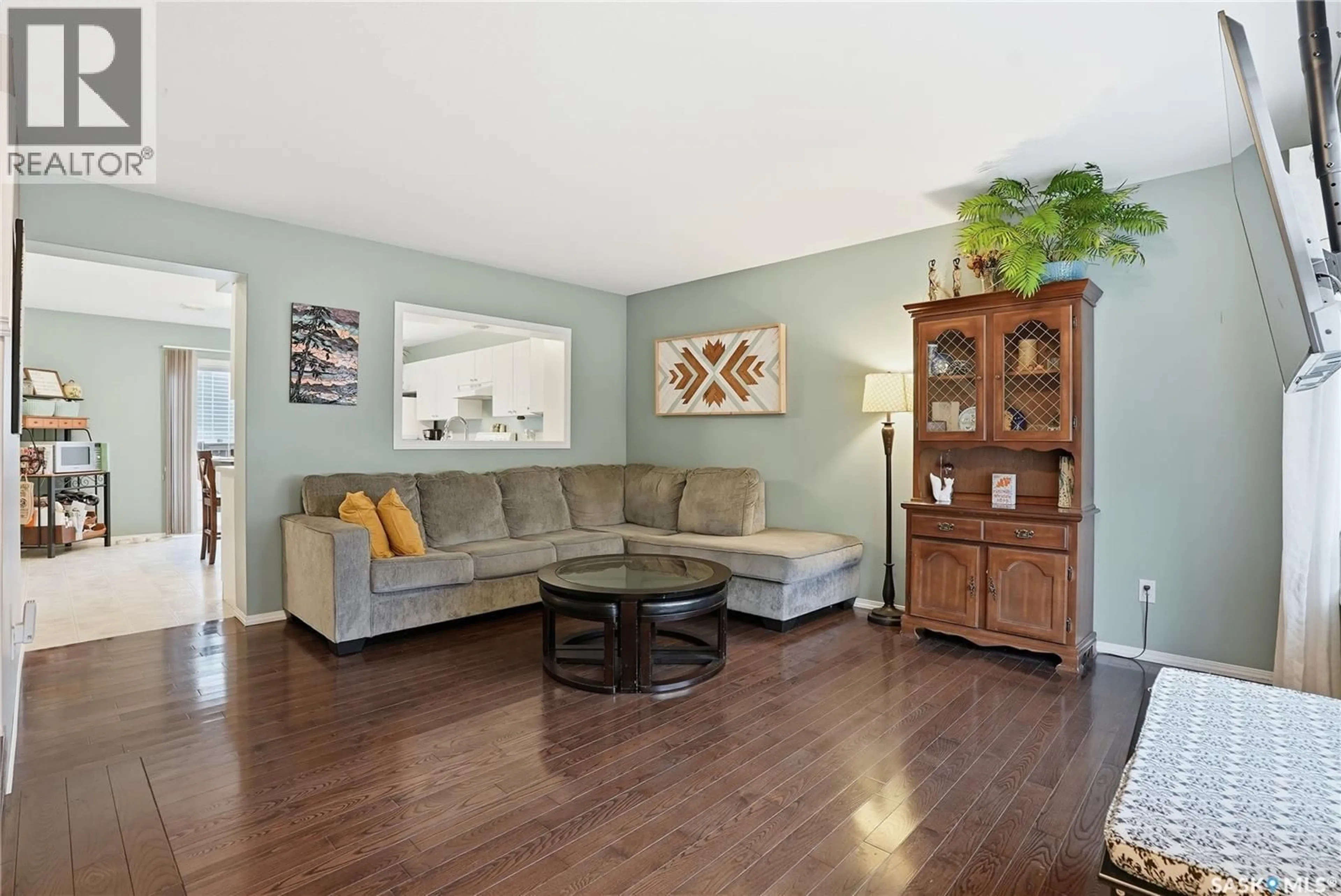 Living room with furniture, wood/laminate floor for 213 663 BECKETT CRESCENT, Saskatoon Saskatchewan S7N4X2
