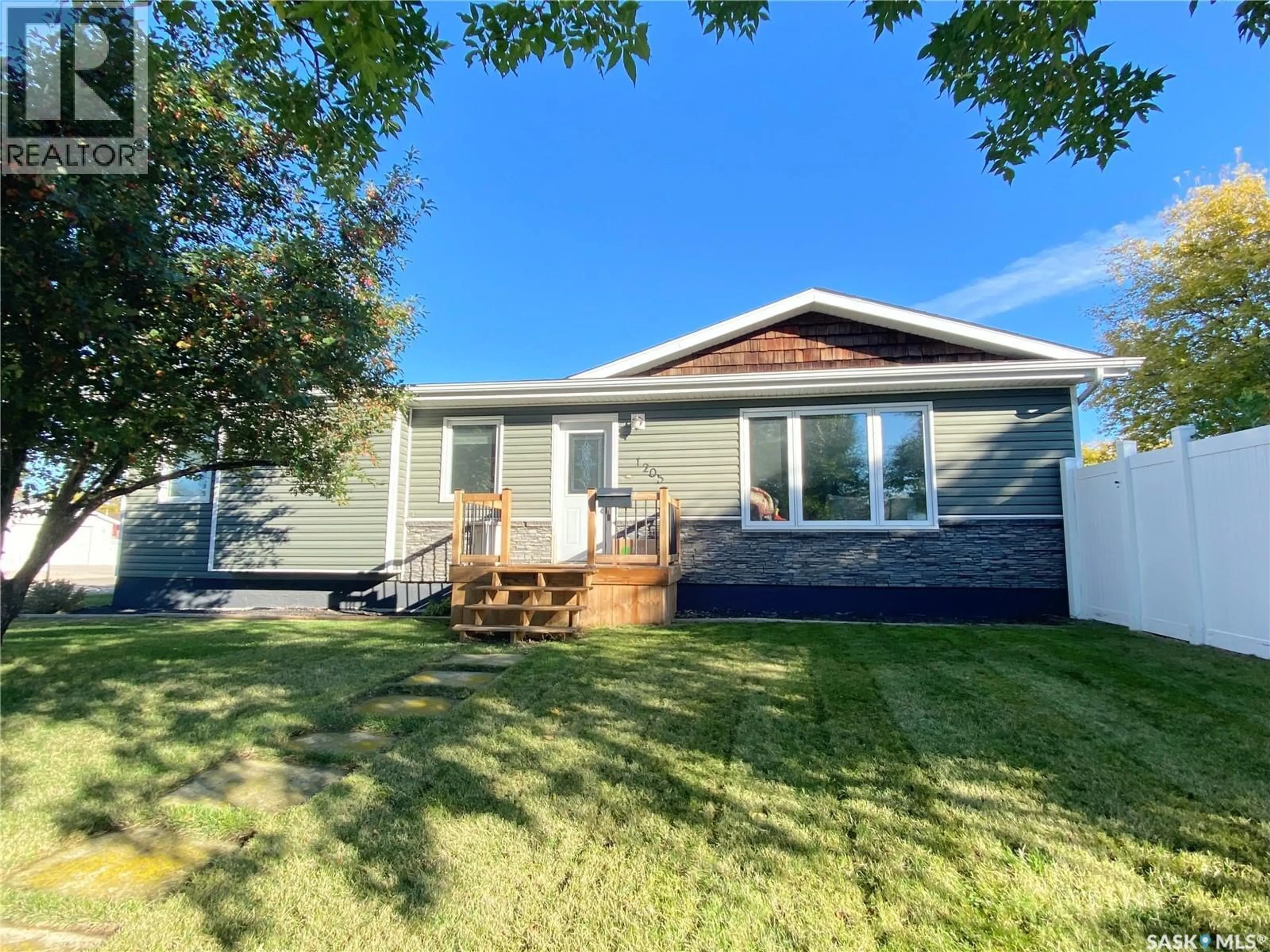 Home with vinyl exterior material, street for 1205 DOUGLAS ROAD, Weyburn Saskatchewan S4H2P9