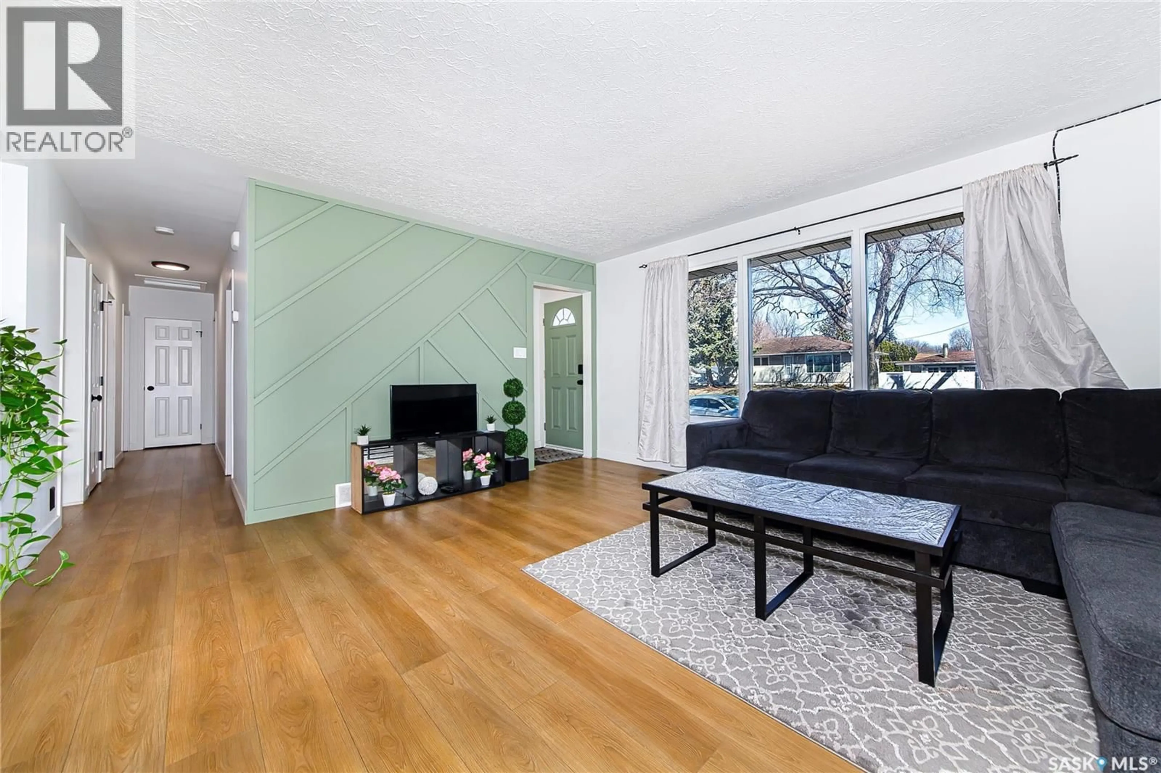 Living room with furniture, wood/laminate floor for 1411 DONALD STREET, Saskatoon Saskatchewan S7W3R6