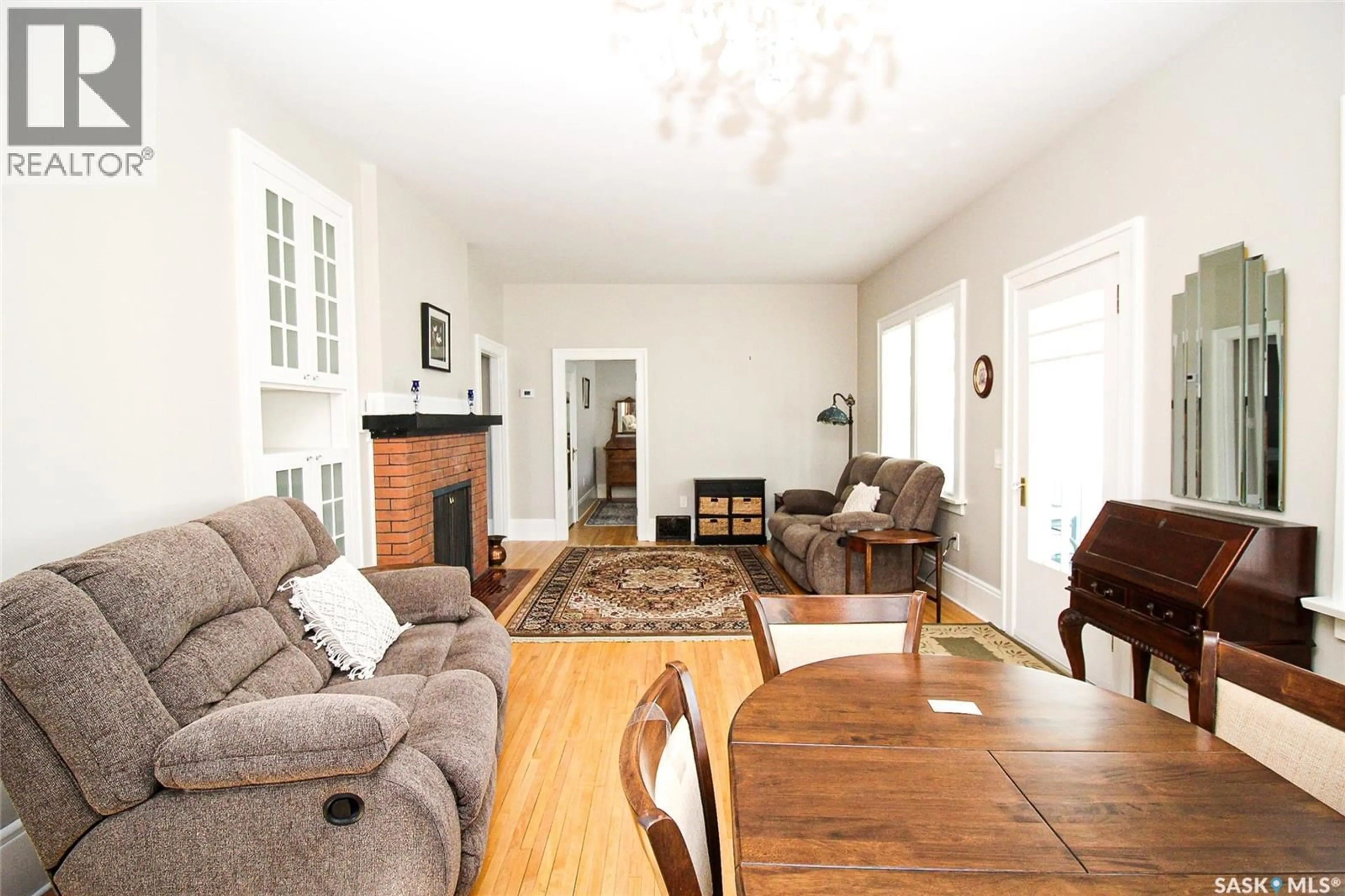 Living room with furniture, wood/laminate floor for 671 2ND STREET, Shaunavon Saskatchewan S0N2M0