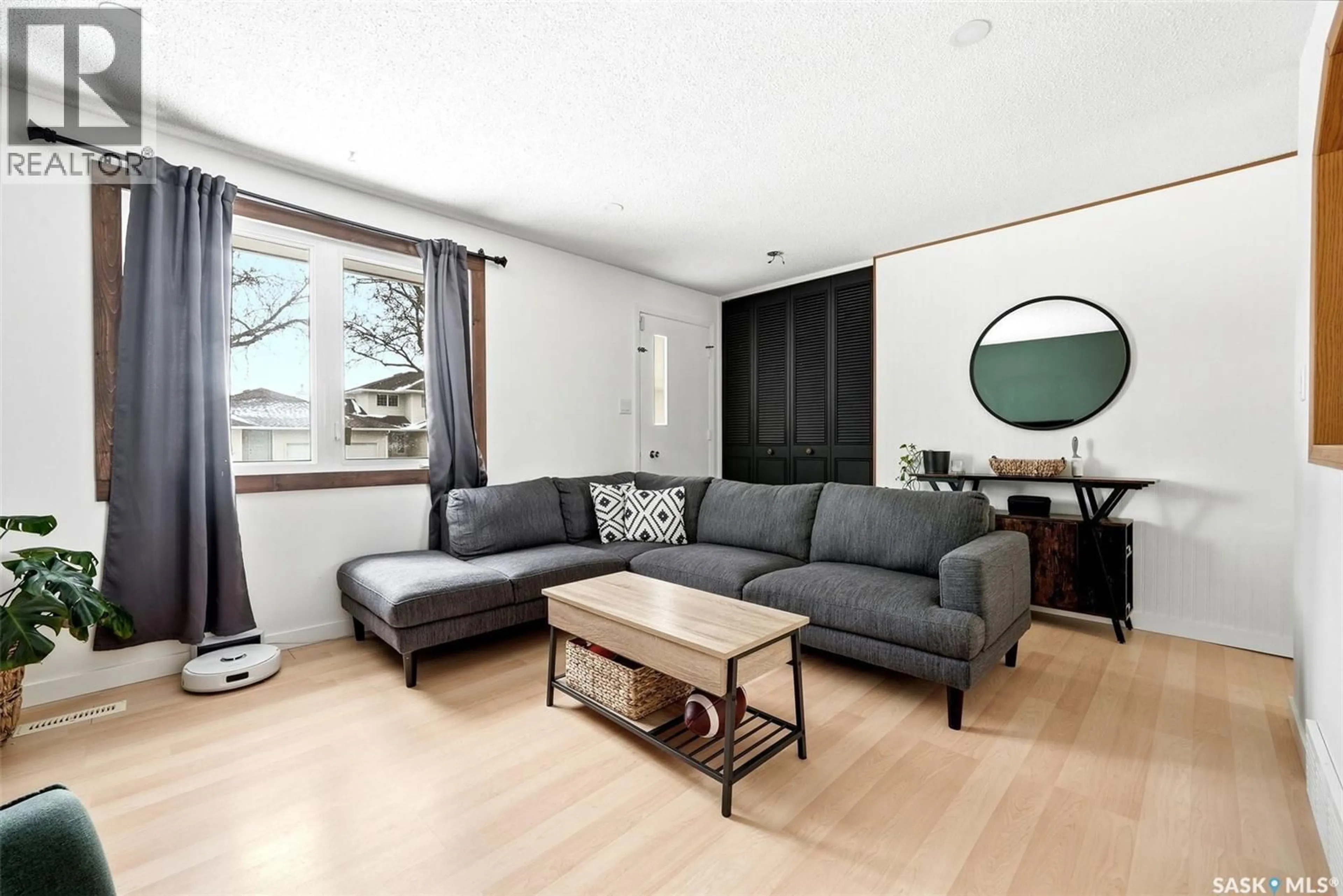 Living room with furniture, wood/laminate floor for 224 MIKKELSON DRIVE, Regina Saskatchewan S4T6C7