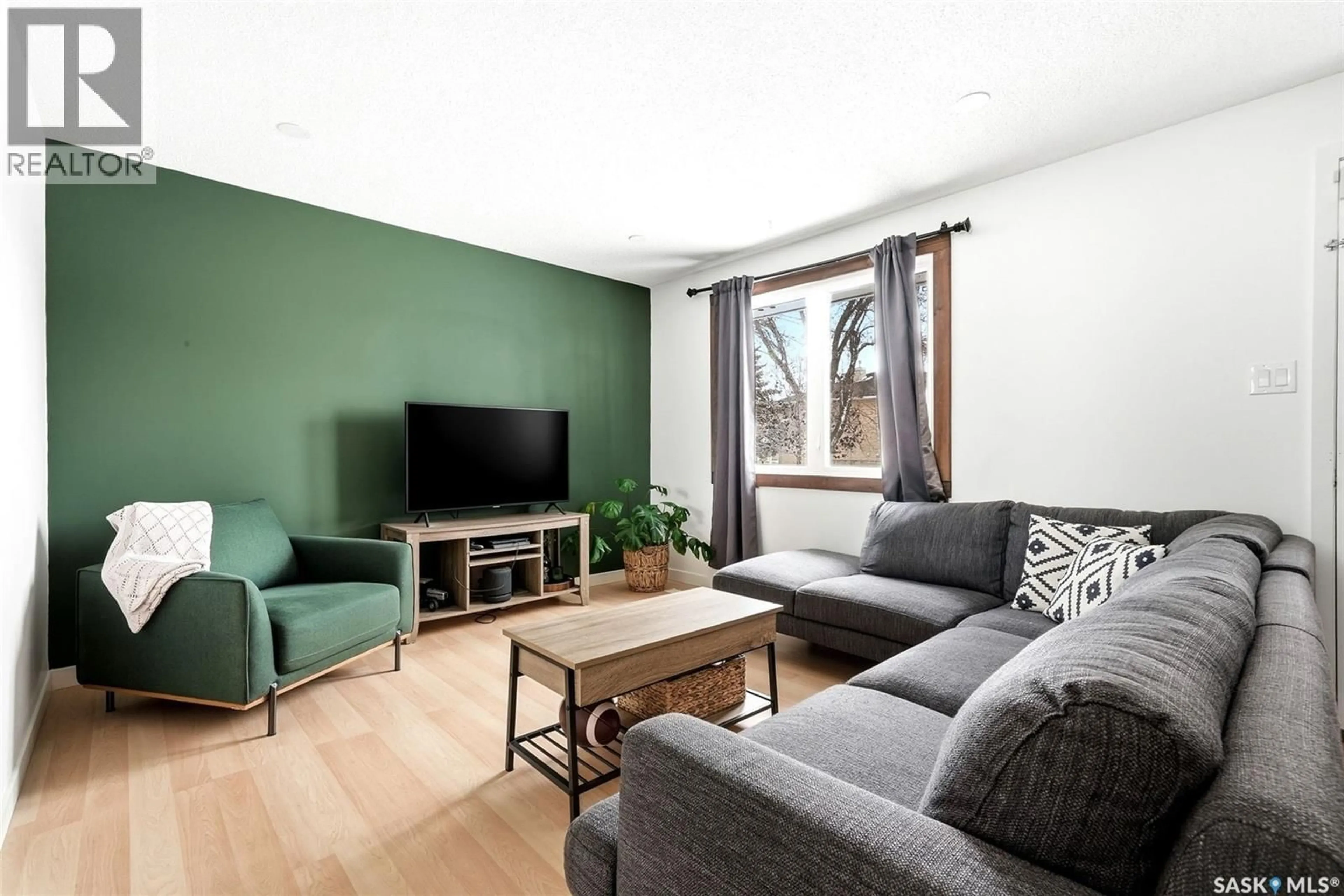 Living room with furniture, wood/laminate floor for 224 MIKKELSON DRIVE, Regina Saskatchewan S4T6C7
