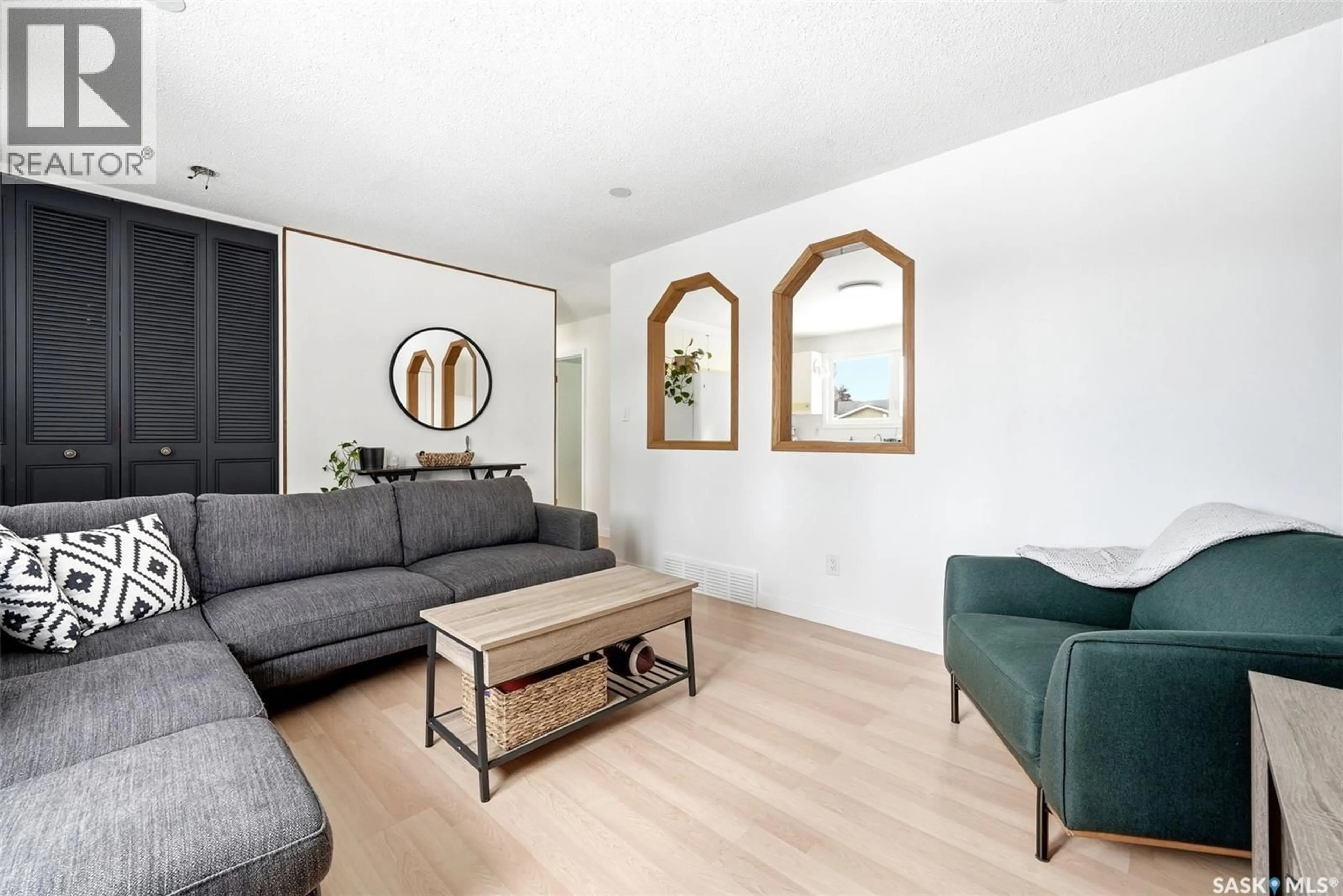 Living room with furniture, wood/laminate floor for 224 MIKKELSON DRIVE, Regina Saskatchewan S4T6C7