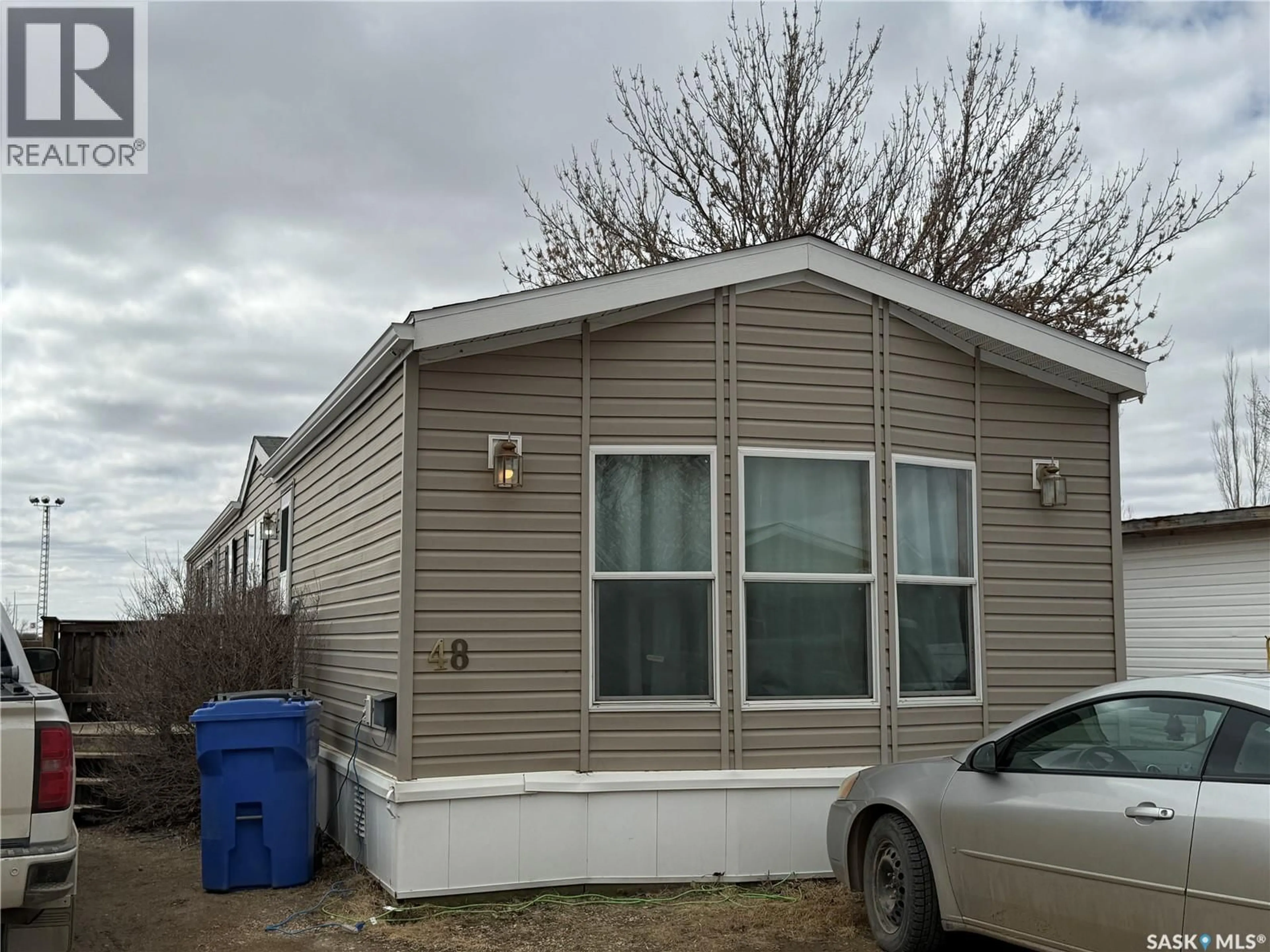 Home with vinyl exterior material, street for 106 - 48 1ST AVENUE, Weyburn Saskatchewan S4H2J1
