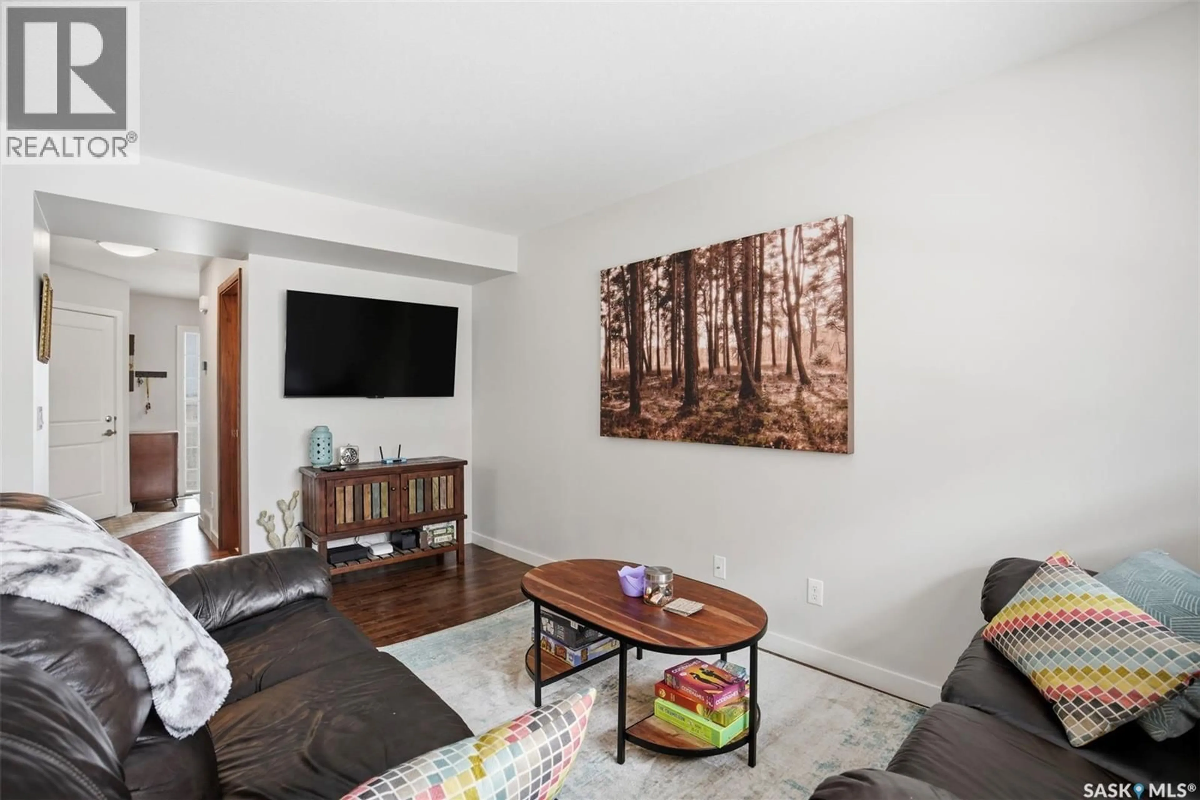 Living room with furniture, wood/laminate floor for 1303 - 314 PATON CRESCENT, Saskatoon Saskatchewan S7W0P6