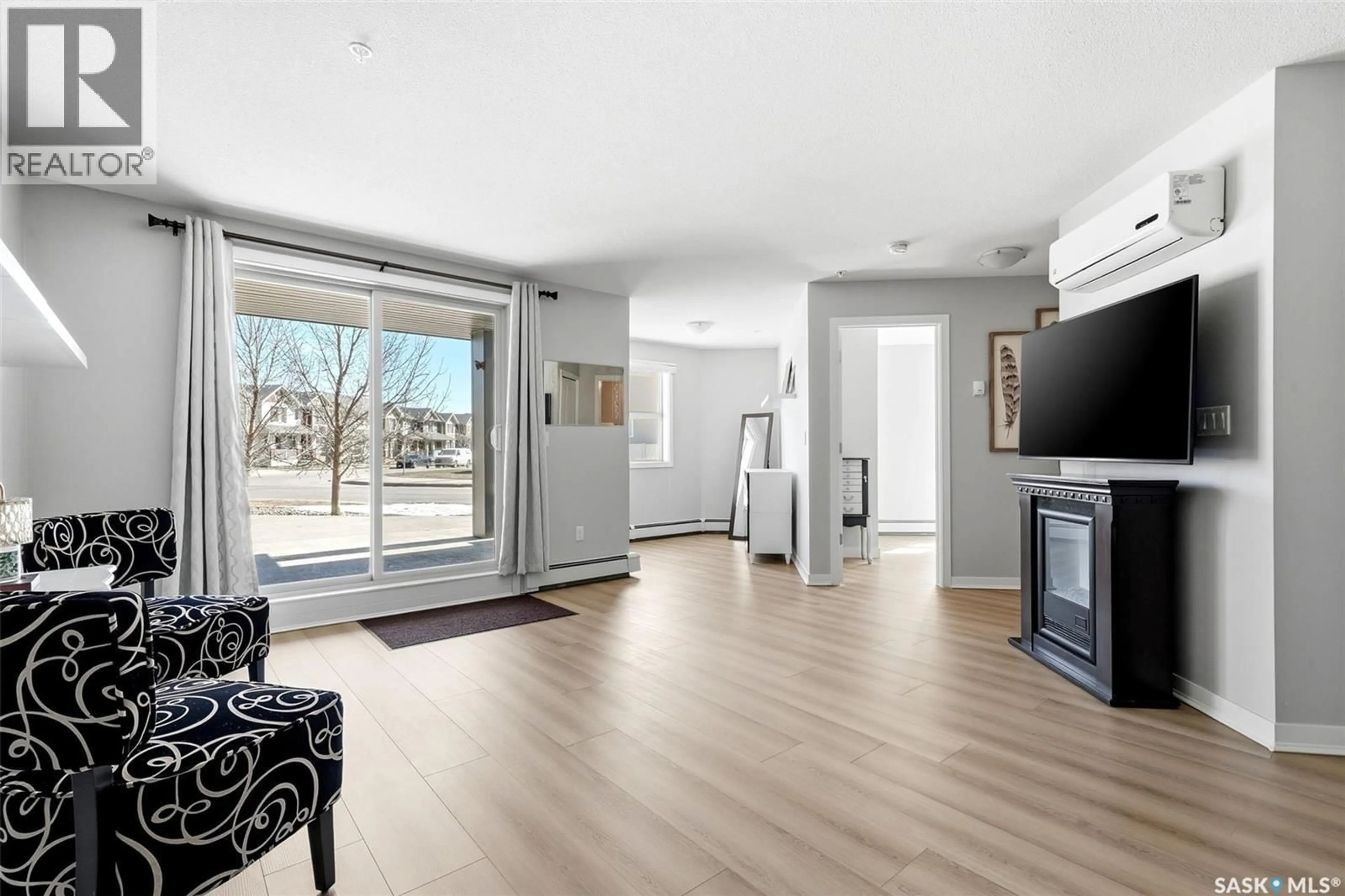 Living room with furniture, wood/laminate floor for 5500 - 1115 MITCHINSON WAY, Regina Saskatchewan S4W0N9