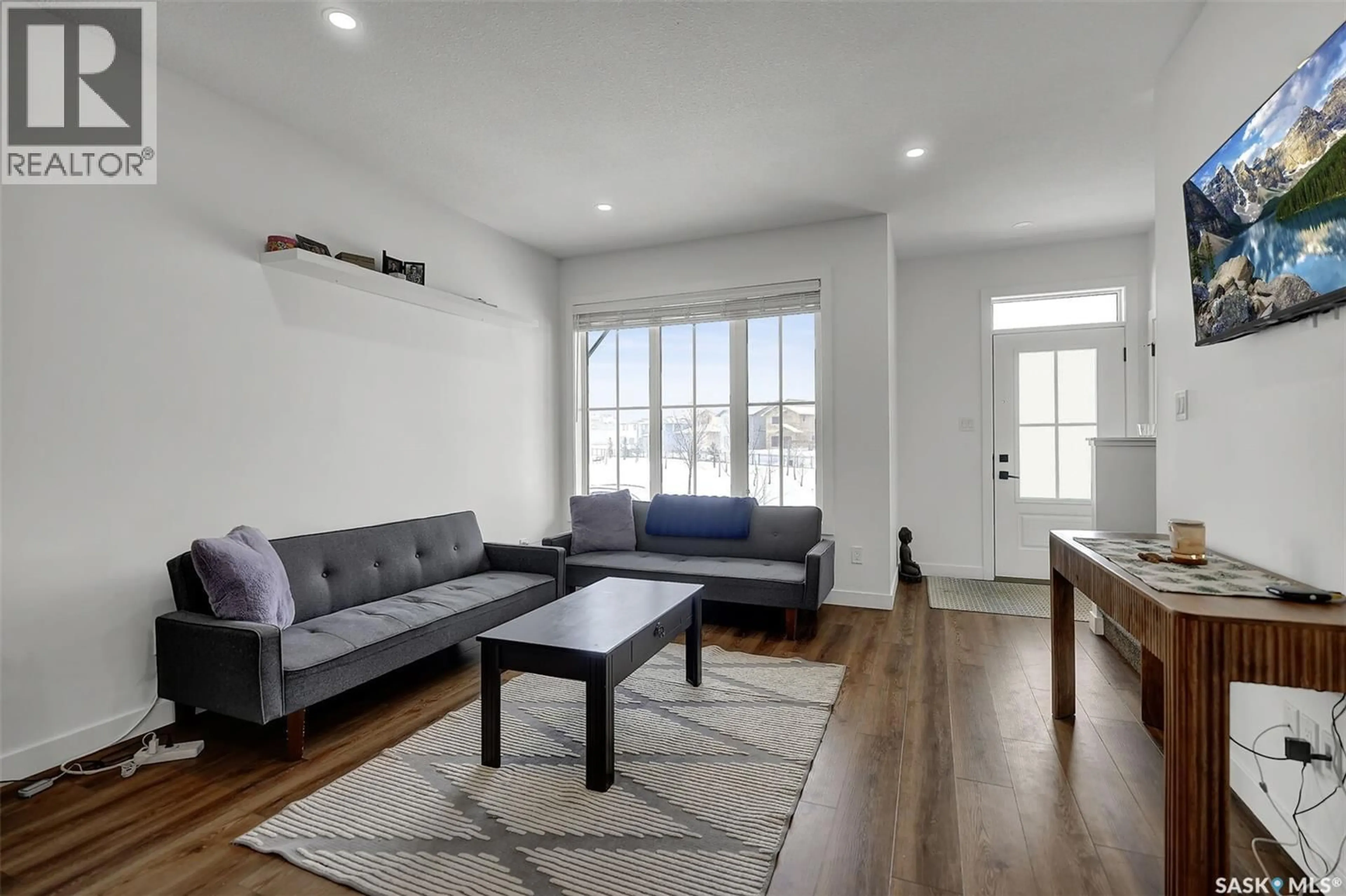 Living room with furniture, wood/laminate floor for 3822 GREEN DIAMOND ROAD, Regina Saskatchewan S4V3T3