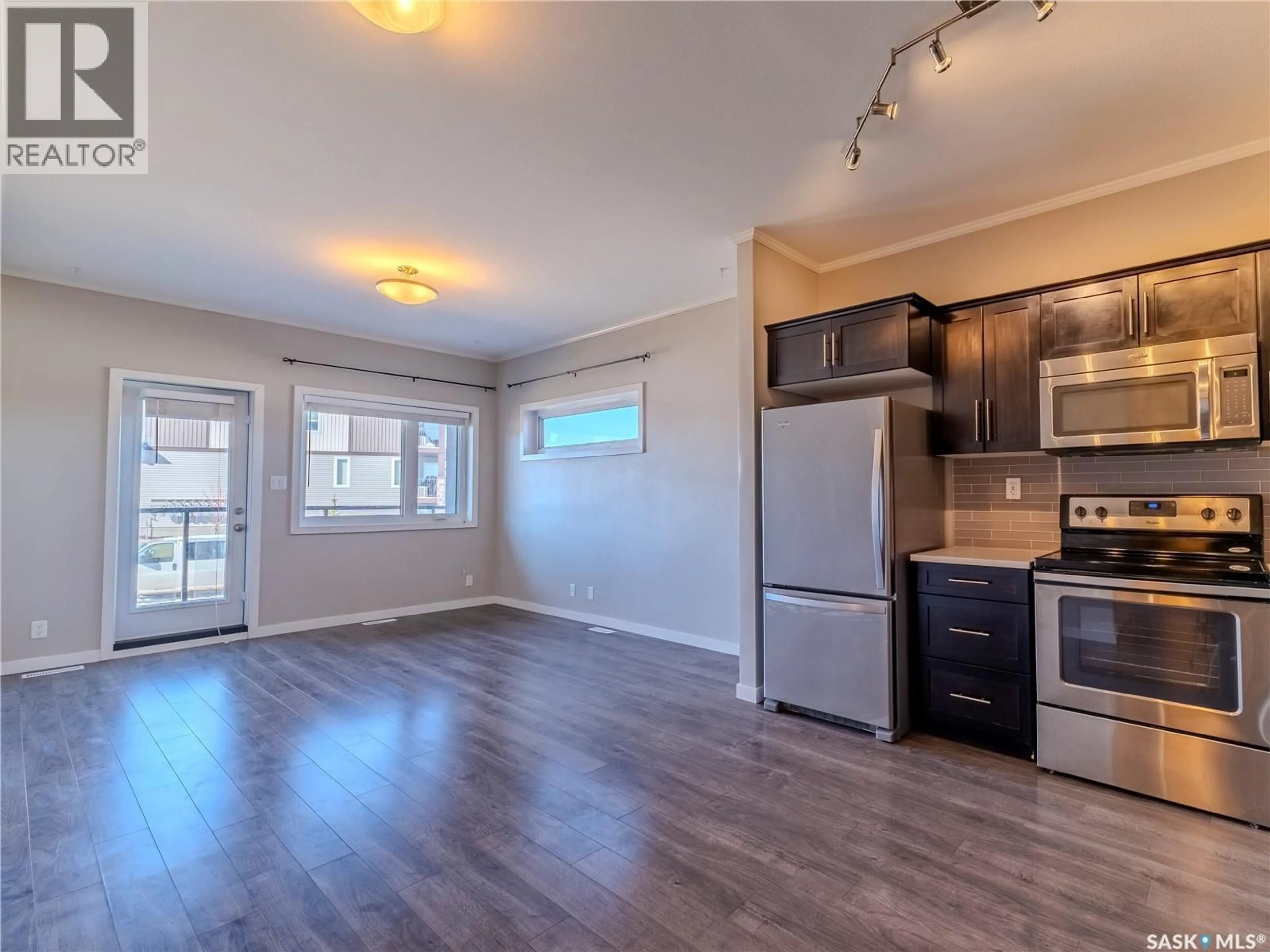 Open concept kitchen, wood/laminate floor for 102 - 720 BALTZAN BOULEVARD, Saskatoon Saskatchewan S7W0W6