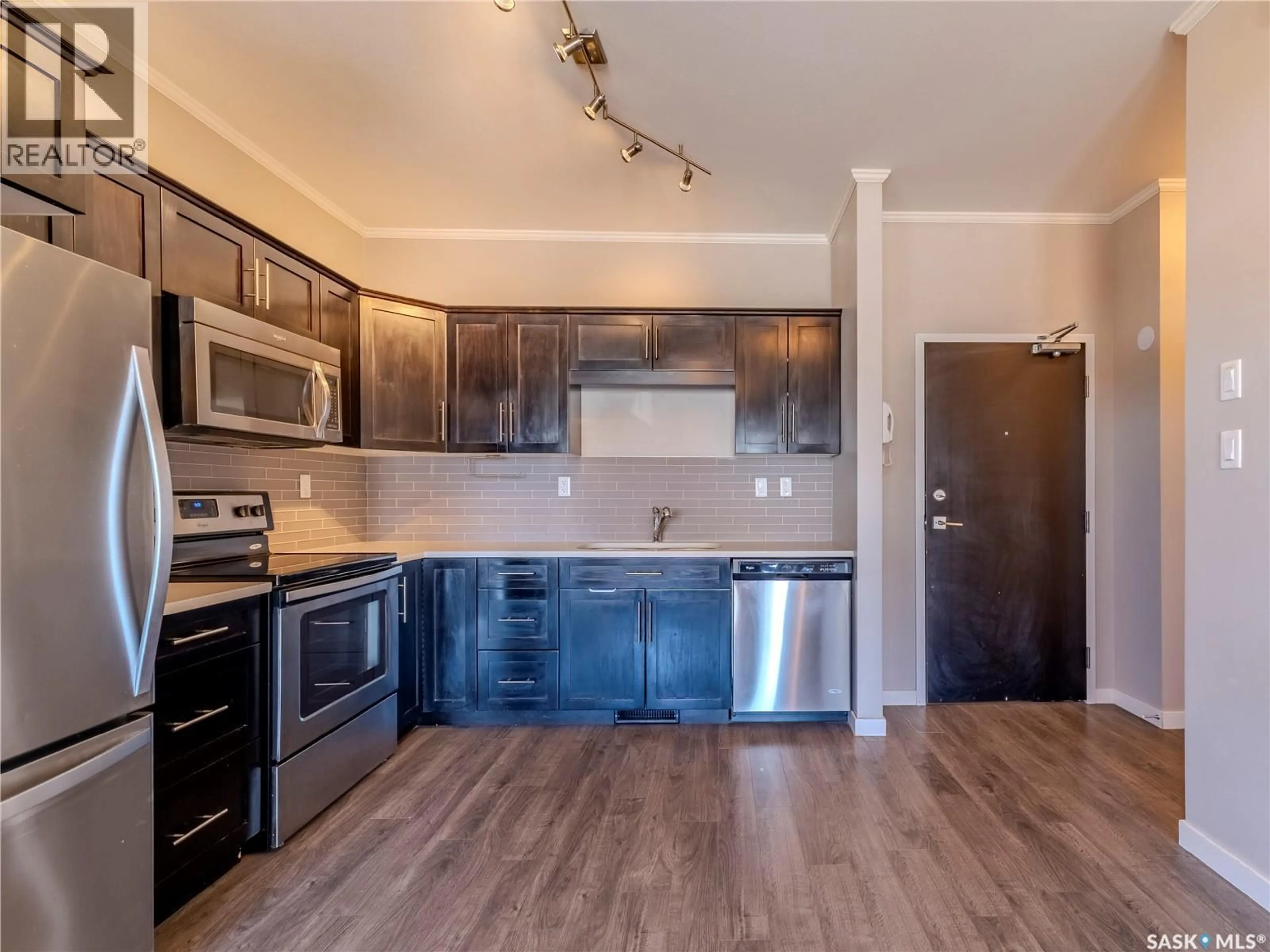 Open concept kitchen, wood/laminate floor for 102 - 720 BALTZAN BOULEVARD, Saskatoon Saskatchewan S7W0W6