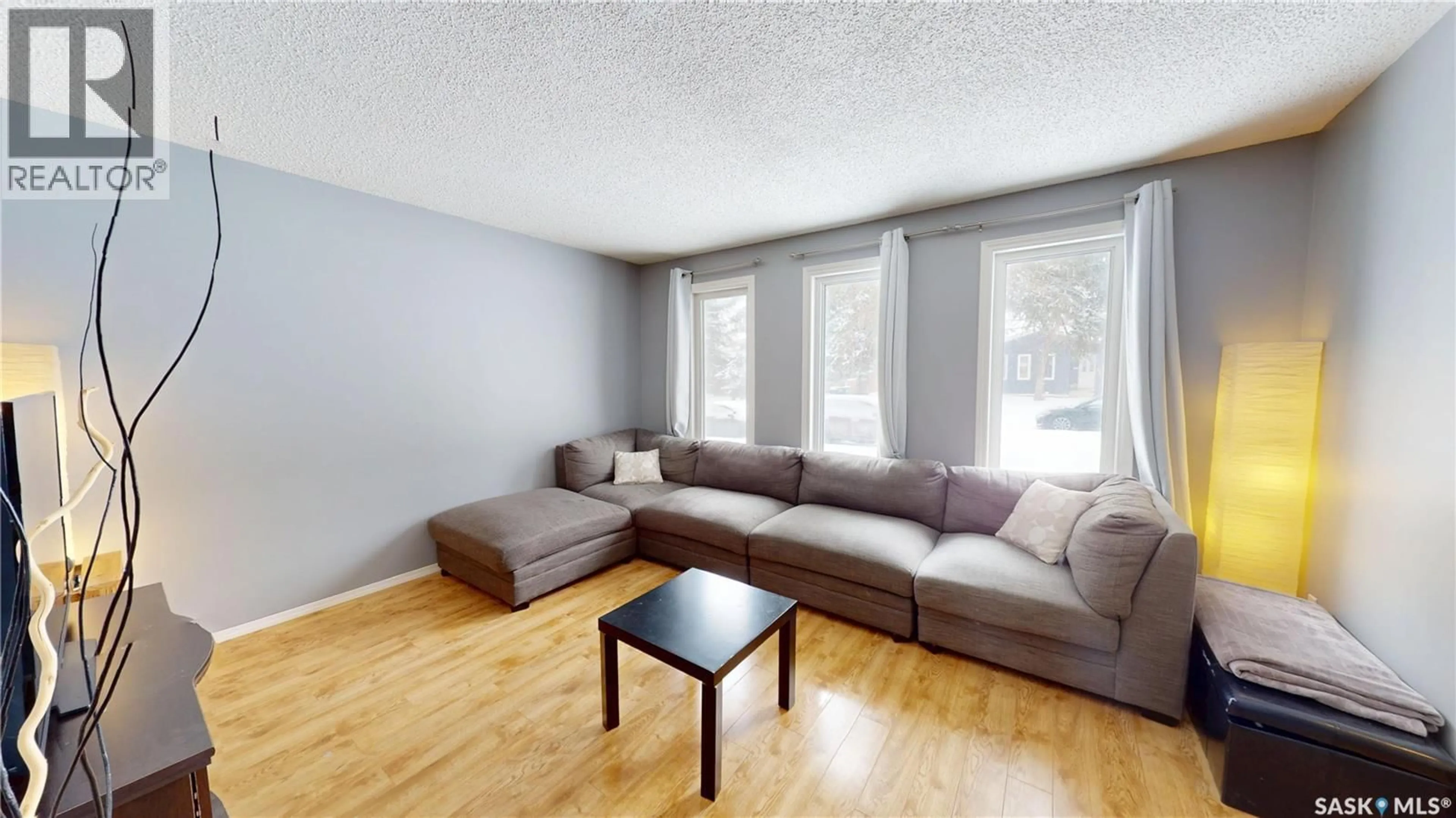 Living room with furniture, wood/laminate floor for 402A GARDINER PLACE, Saskatoon Saskatchewan S7N2S9