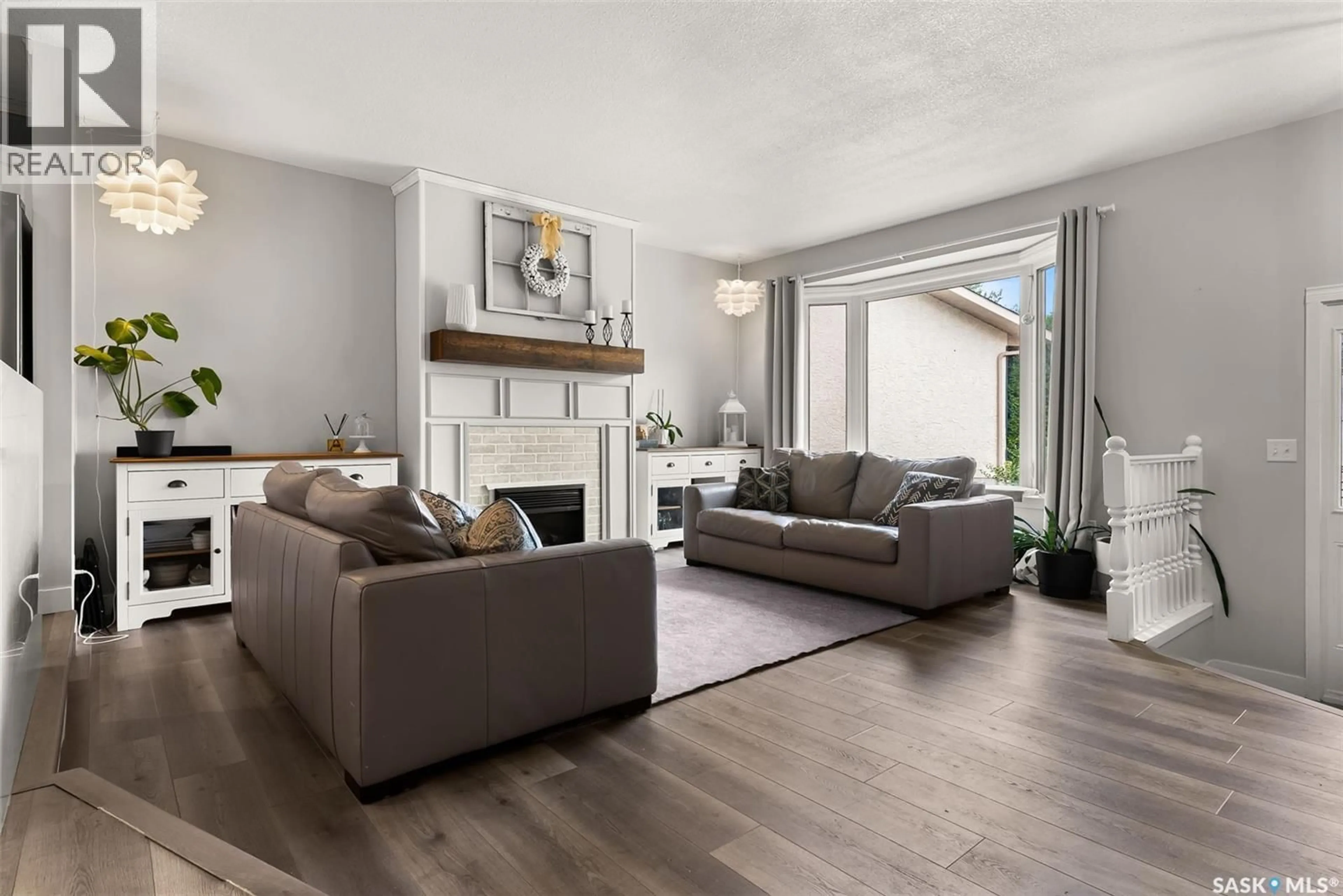 Living room with furniture, wood/laminate floor for 21 RIDER BAY, Grand Coulee Saskatchewan S4M0A3