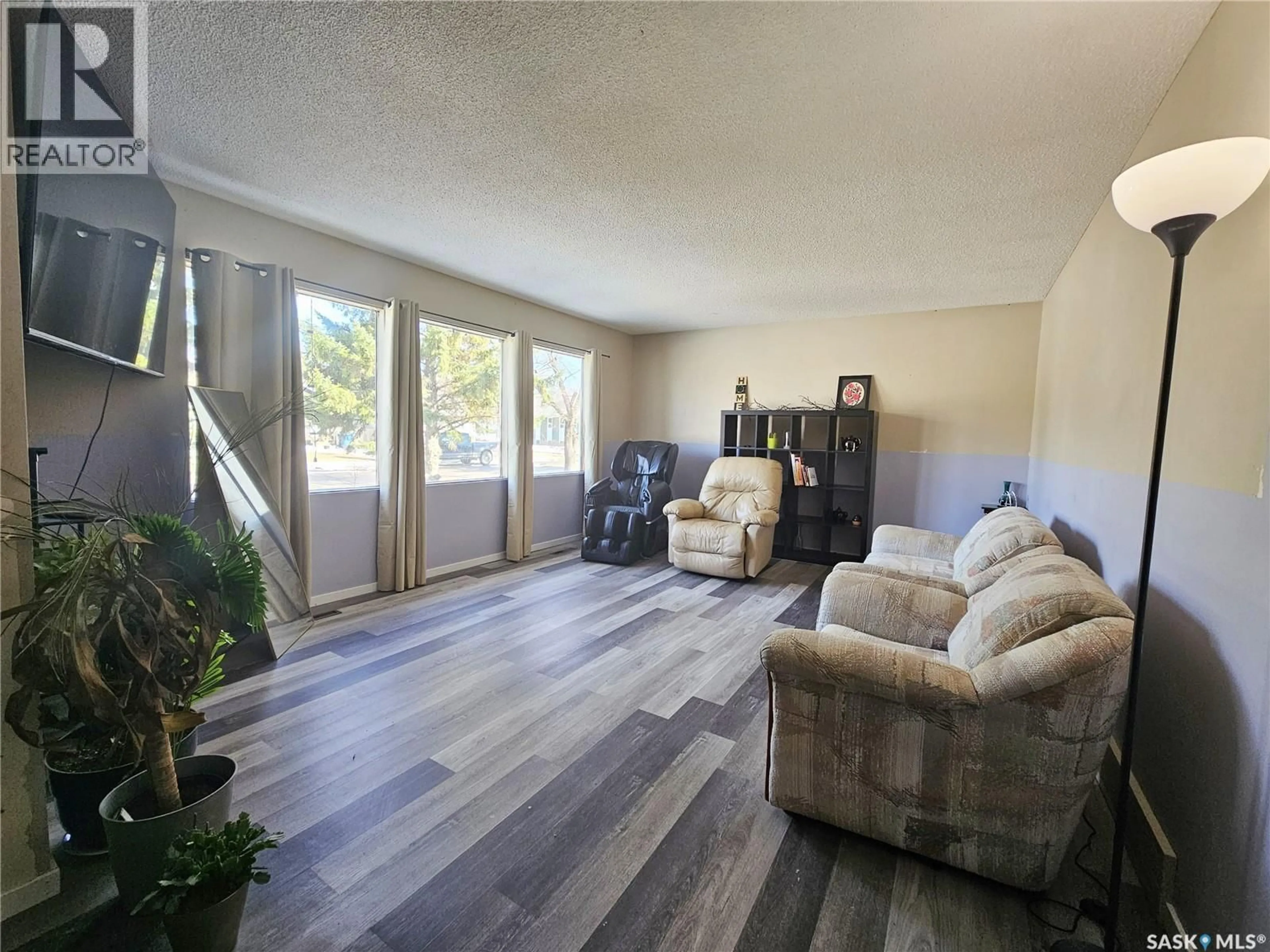 Living room with furniture, wood/laminate floor for 1641 103RD STREET, North Battleford Saskatchewan S9A1L6