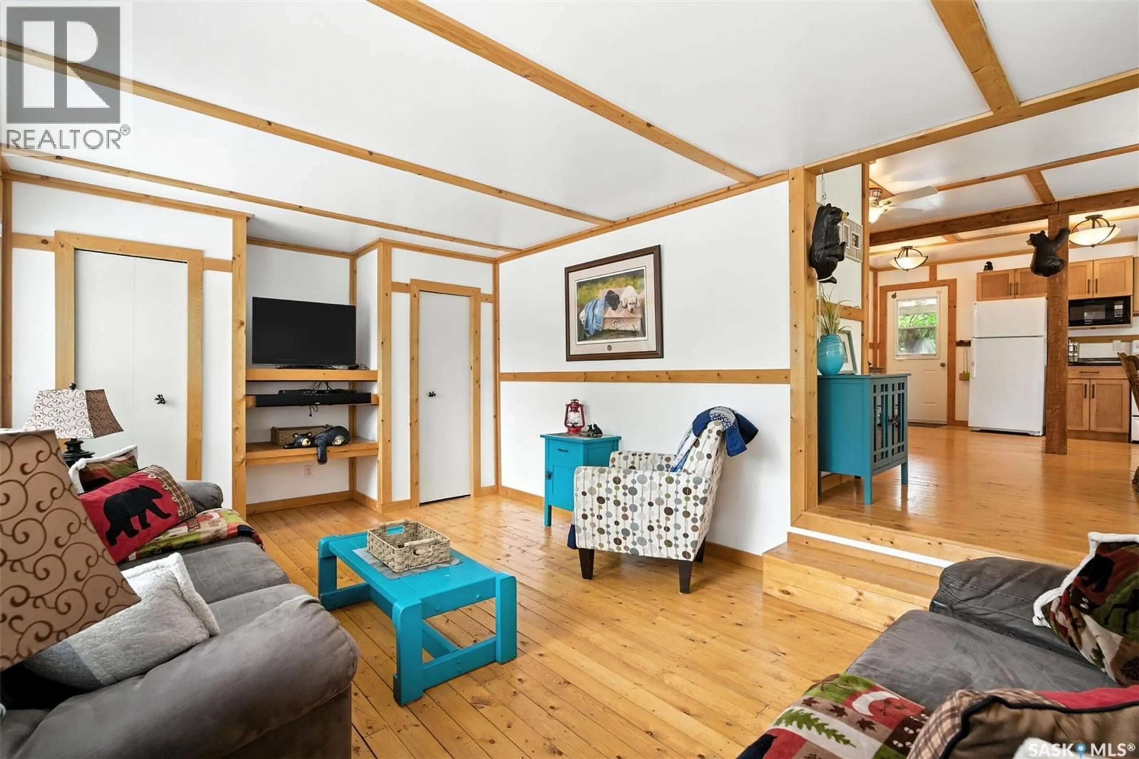 Living room with furniture, wood/laminate floor for 3B STONEY LAKE ROAD, Humboldt Rm No. 370 Saskatchewan S0K2A0