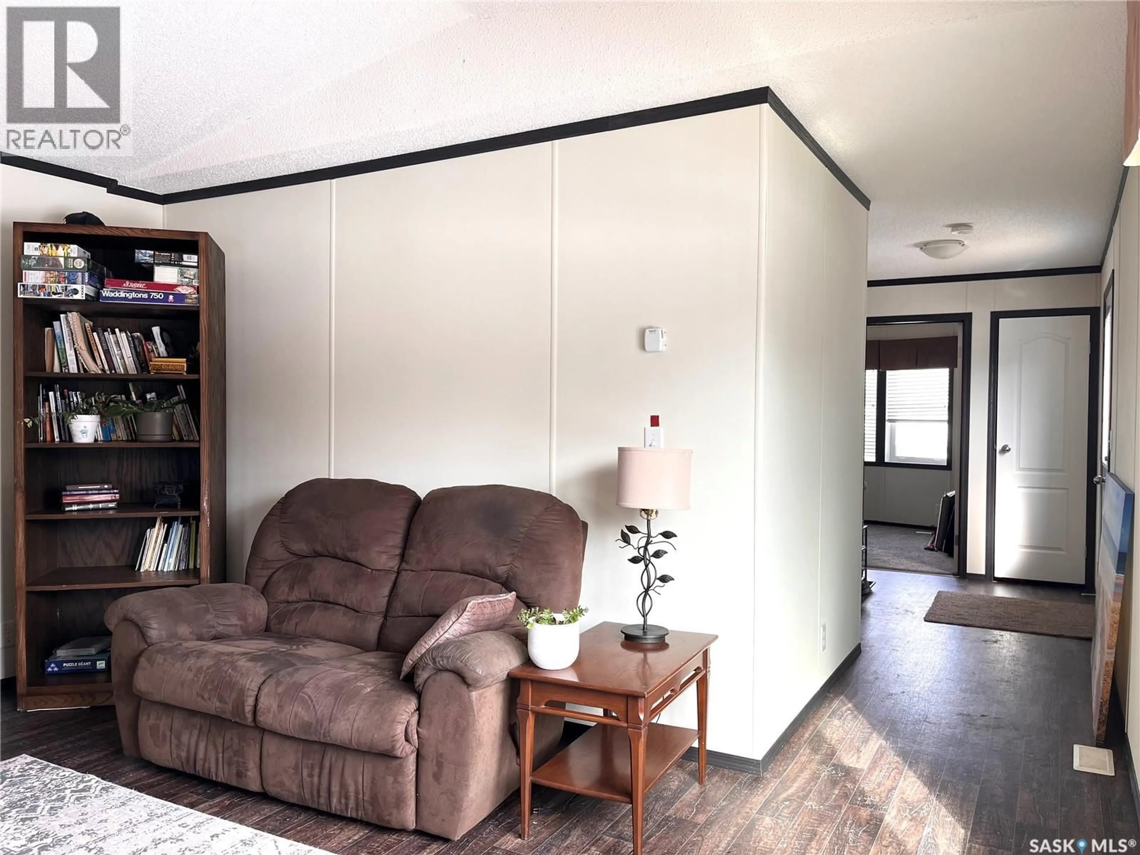 Living room with furniture, wood/laminate floor for 218 4TH STREET, Nipawin Saskatchewan S0E1E0