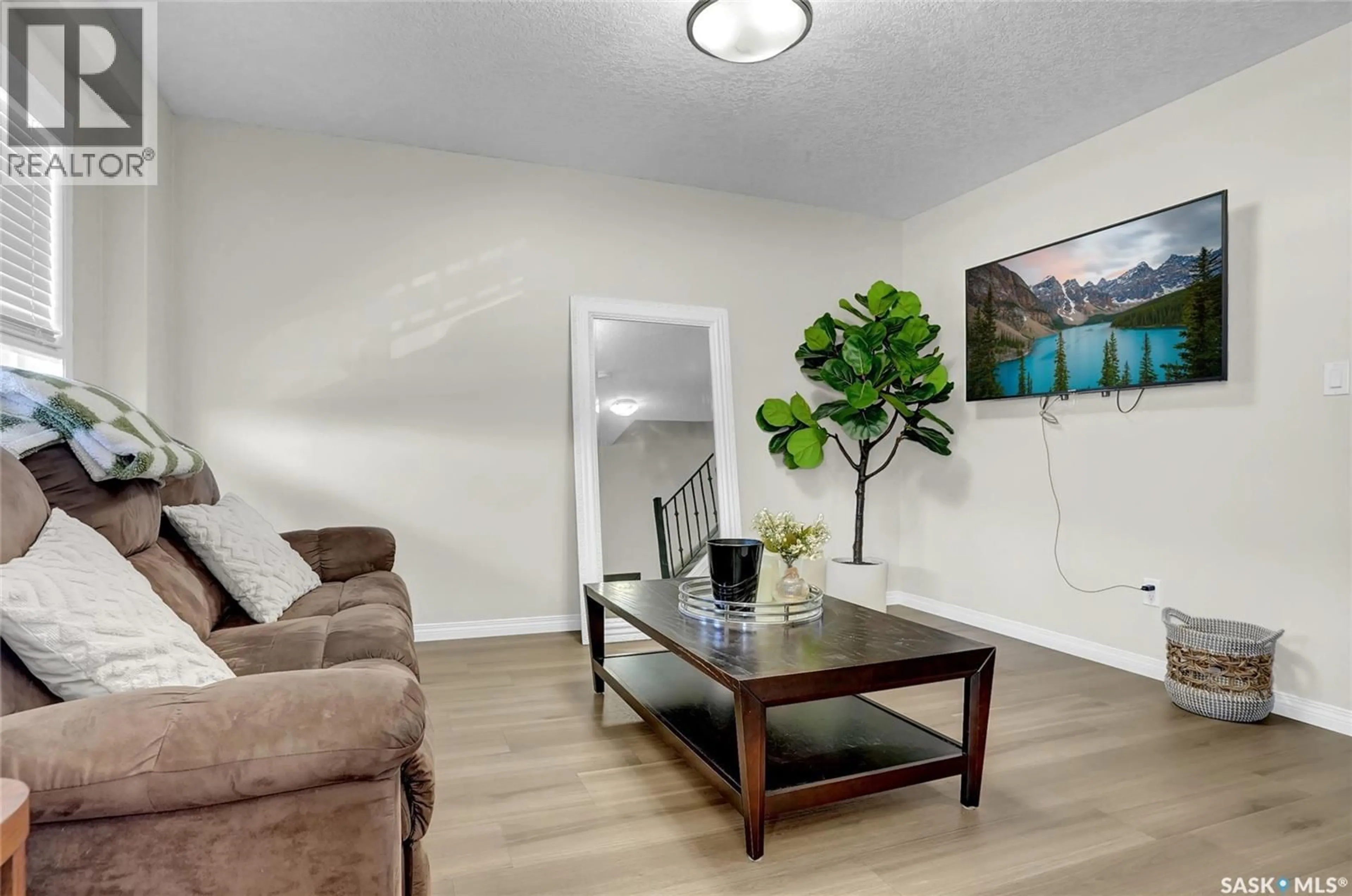 Living room with furniture, wood/laminate floor for 405 - 3826 DEWDNEY AVENUE, Regina Saskatchewan S4Z0A6