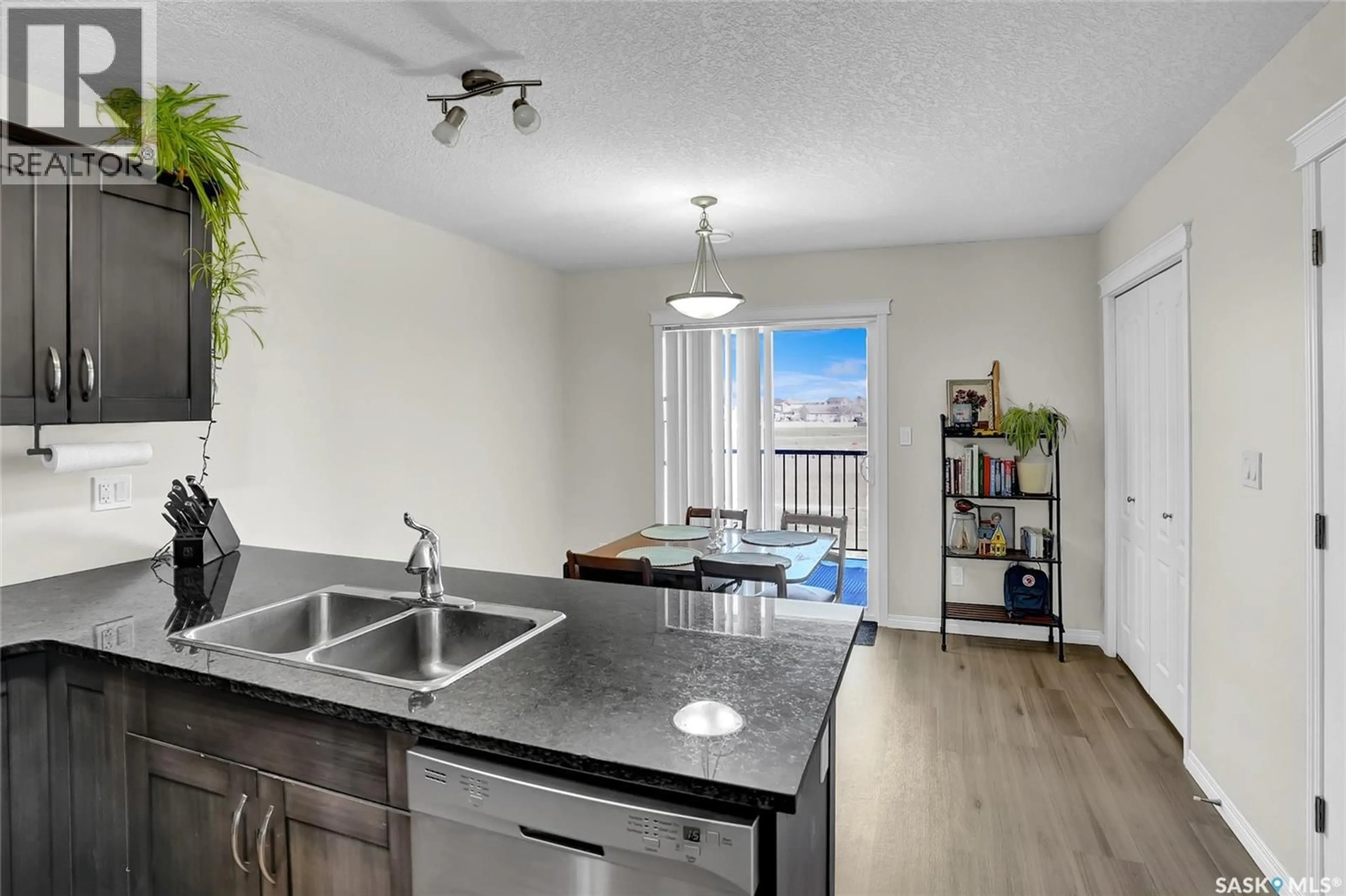 Open concept kitchen, wood/laminate floor for 405 - 3826 DEWDNEY AVENUE, Regina Saskatchewan S4Z0A6
