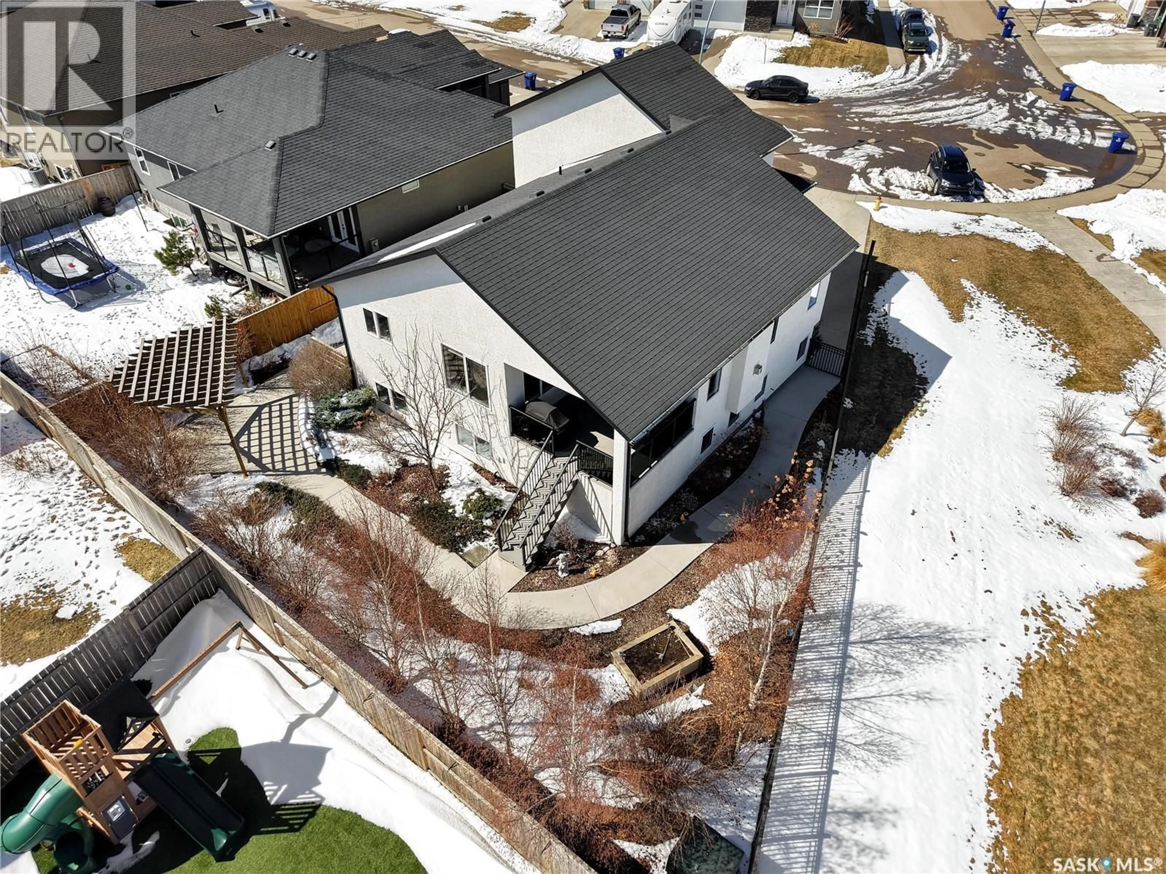 A pic from outside/outdoor area/front of a property/back of a property/a pic from drone, street for 803 SALLOUM CRESCENT, Saskatoon Saskatchewan S7W0N3
