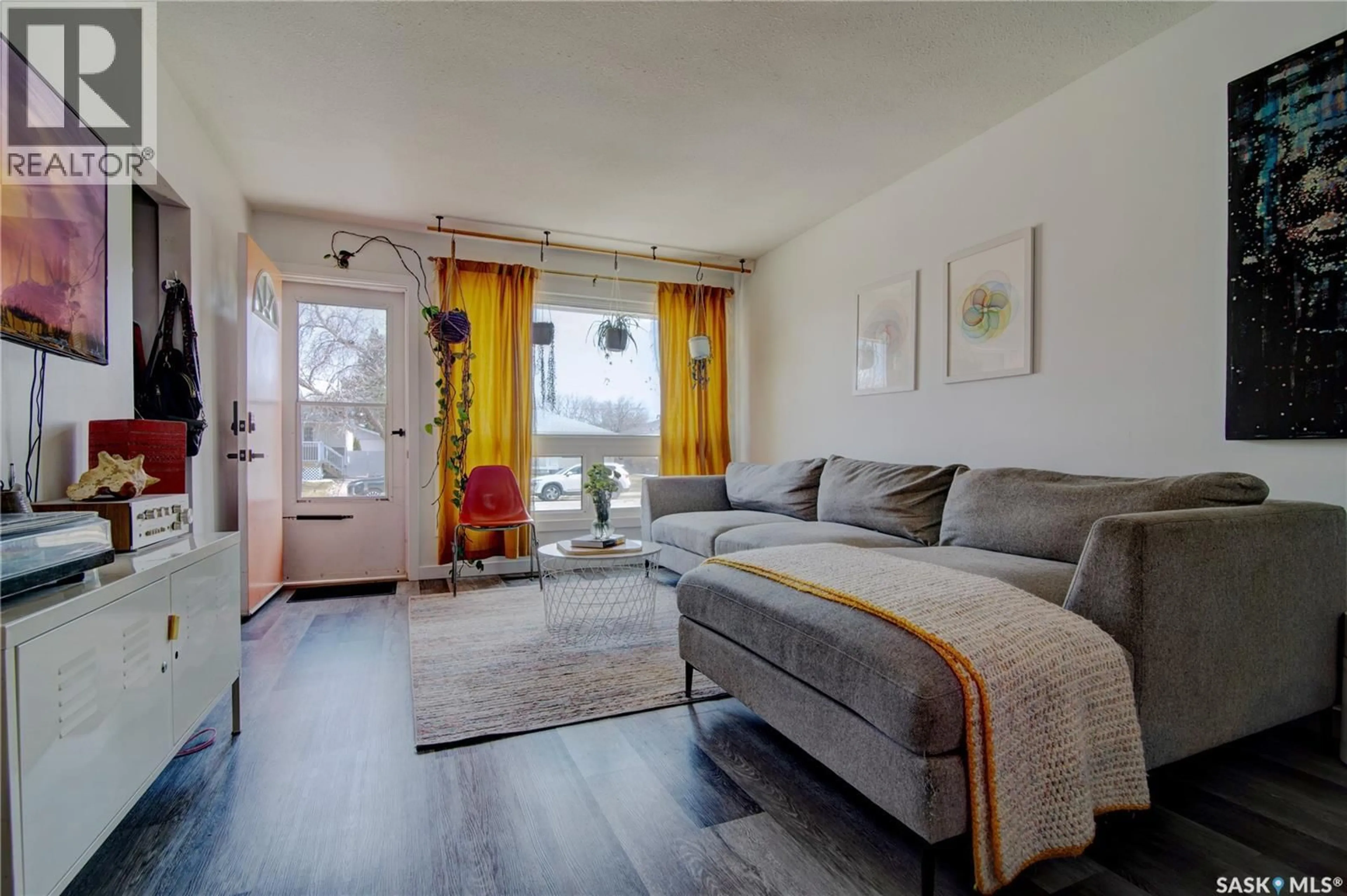 Living room with furniture, wood/laminate floor for 1144 CAMPBELL STREET, Regina Saskatchewan S4T5P6