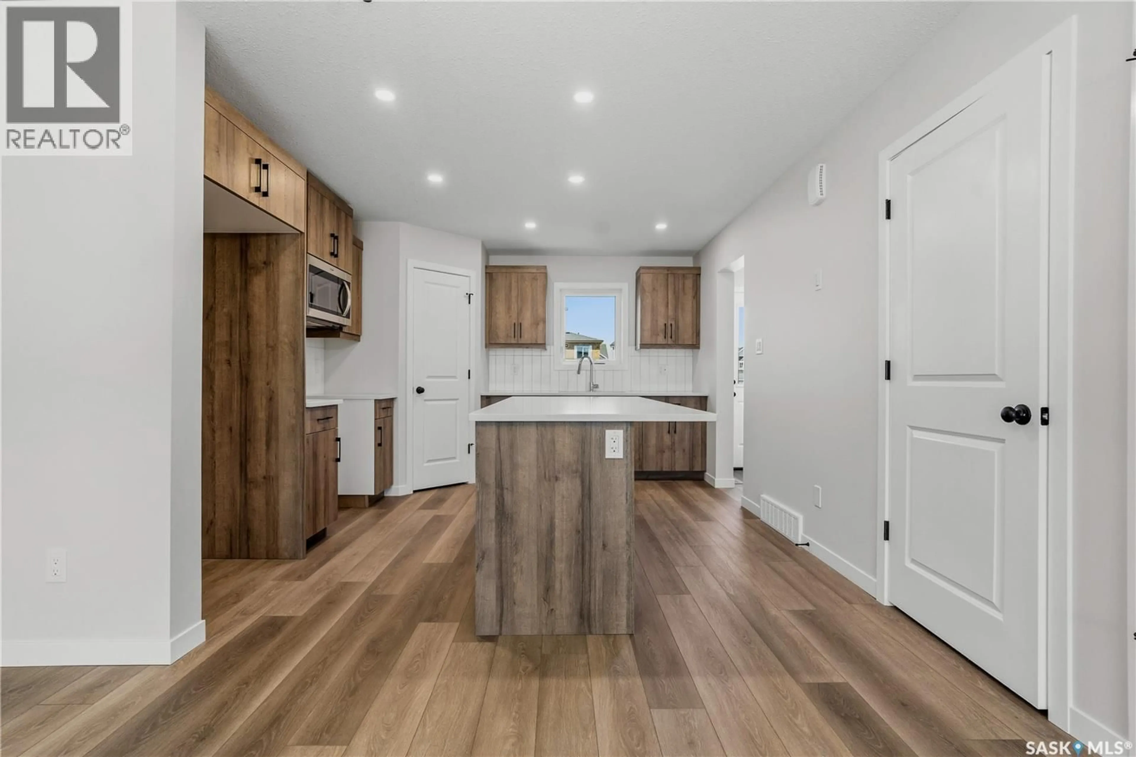 Open concept kitchen, wood/laminate floor for 3156 GREEN TURTLE ROAD, Regina Saskatchewan S4V4C5