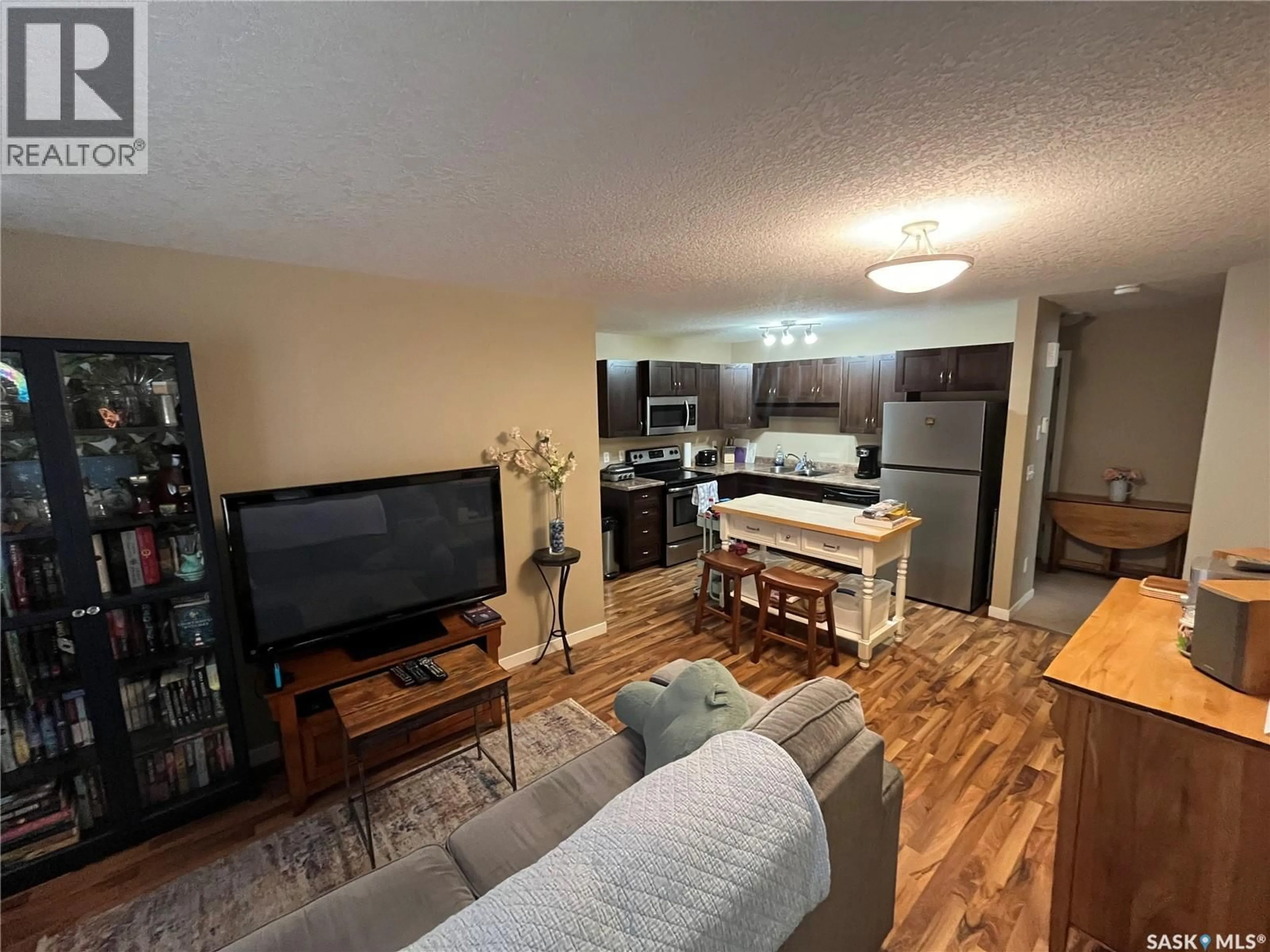 Living room with furniture, wood/laminate floor for 51 - 5565 BLAKE CRESCENT, Regina Saskatchewan S4A0J1