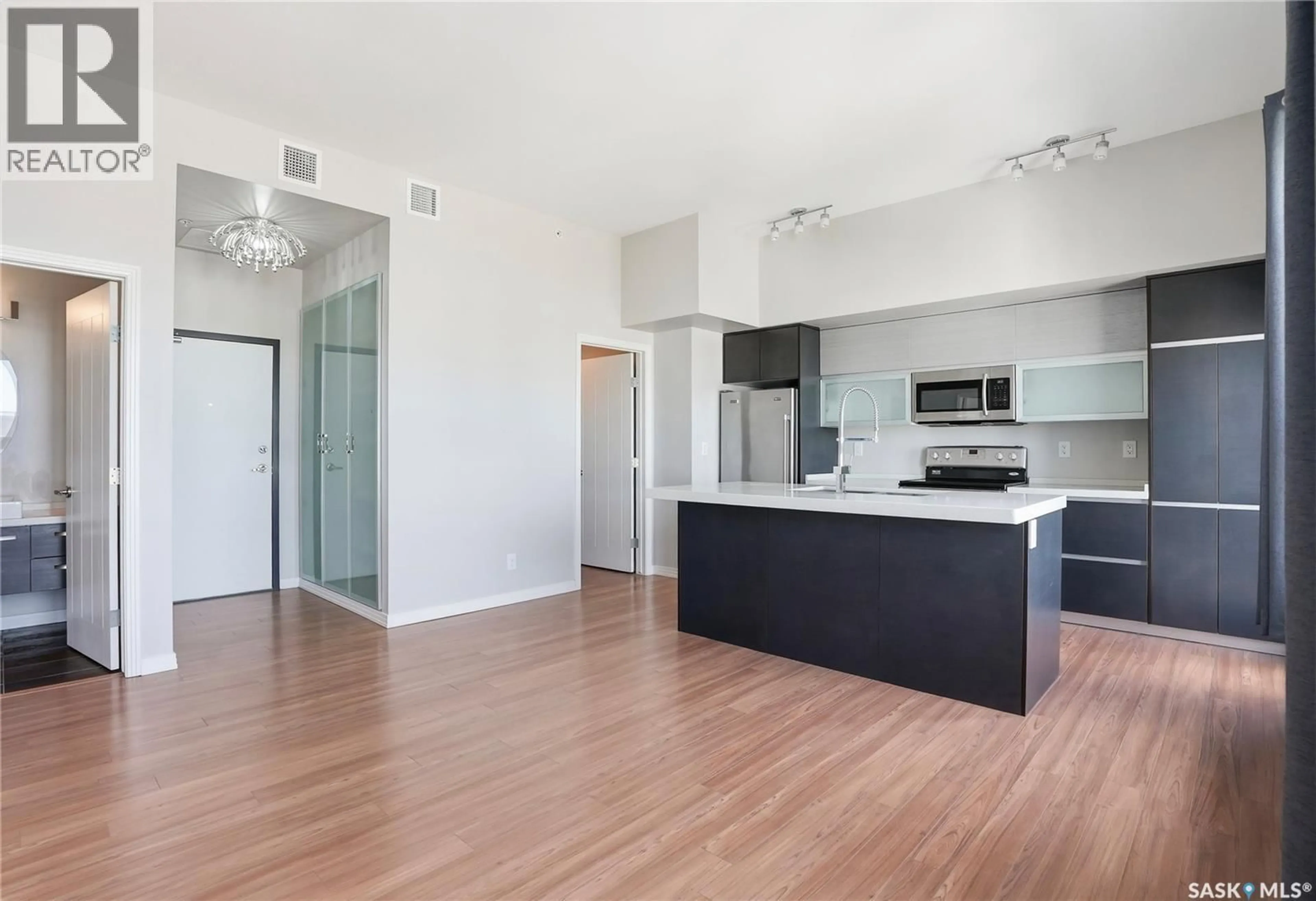 Open concept kitchen, wood/laminate floor for 235 - 308 EVERGREEN SQUARE, Saskatoon Saskatchewan S7W0T9