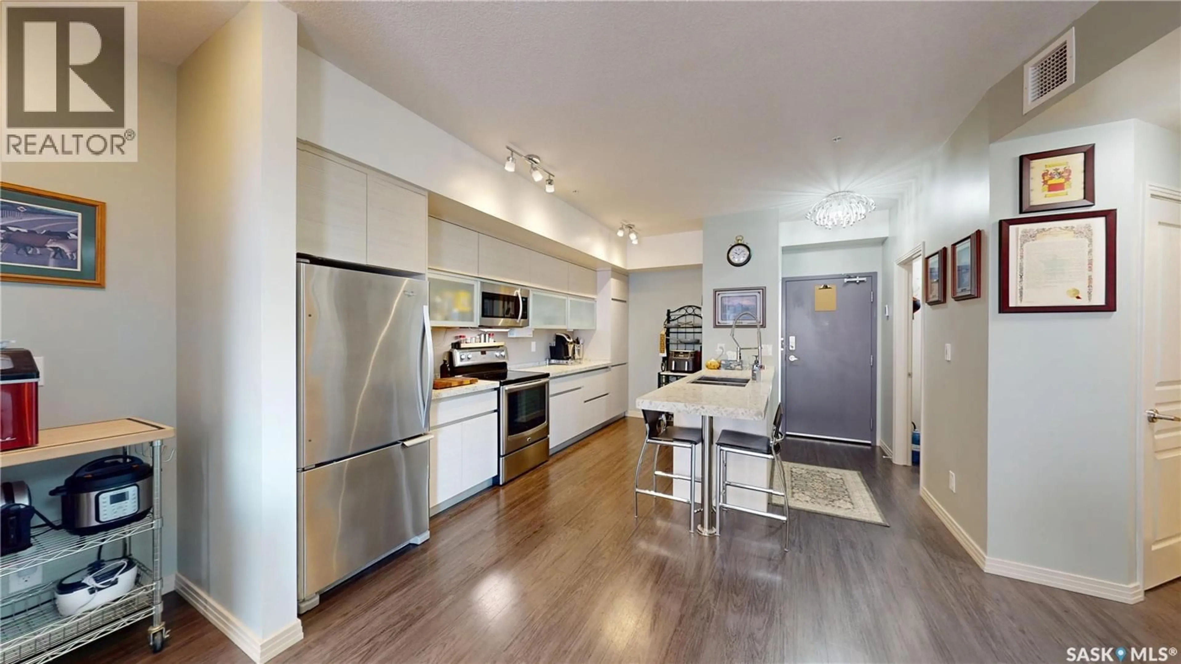 Open concept kitchen, wood/laminate floor for 205 223 EVERGREEN SQUARE, Saskatoon Saskatchewan S7W0W2