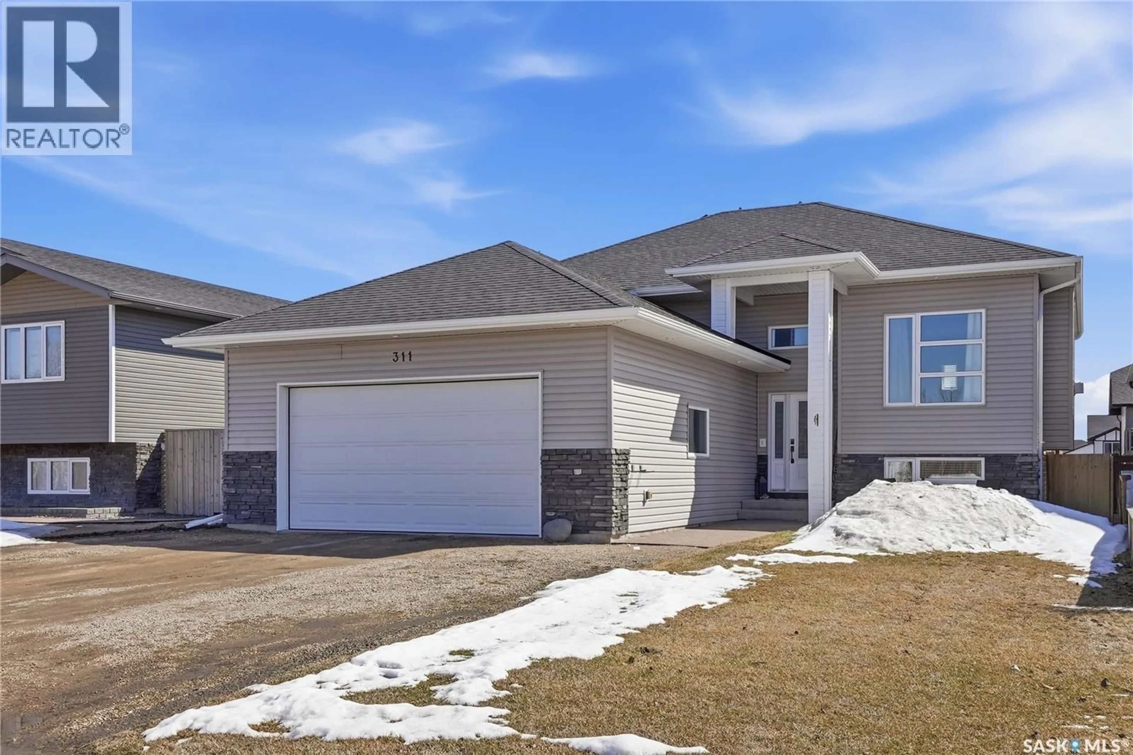 Home with vinyl exterior material, street for 311 RIGMOR STREET, Warman Saskatchewan S0K4S3
