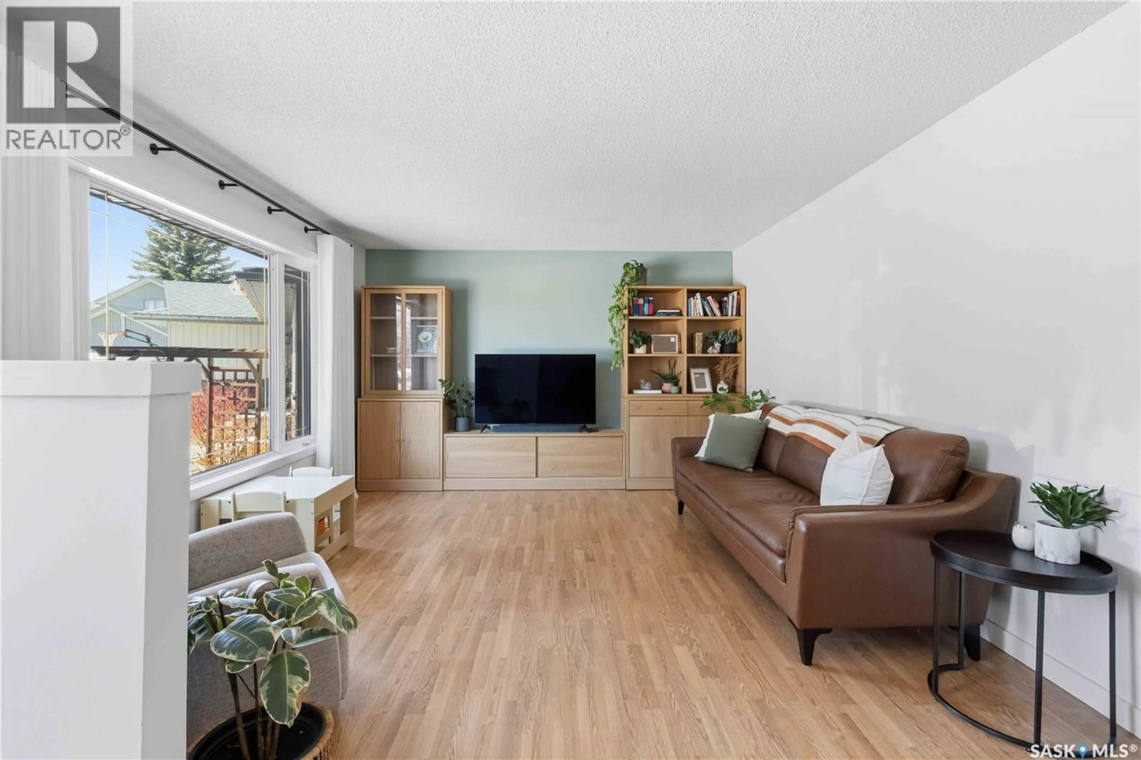 Living room with furniture, wood/laminate floor for 363 CANDLE CRESCENT, Saskatoon Saskatchewan S7K5A5