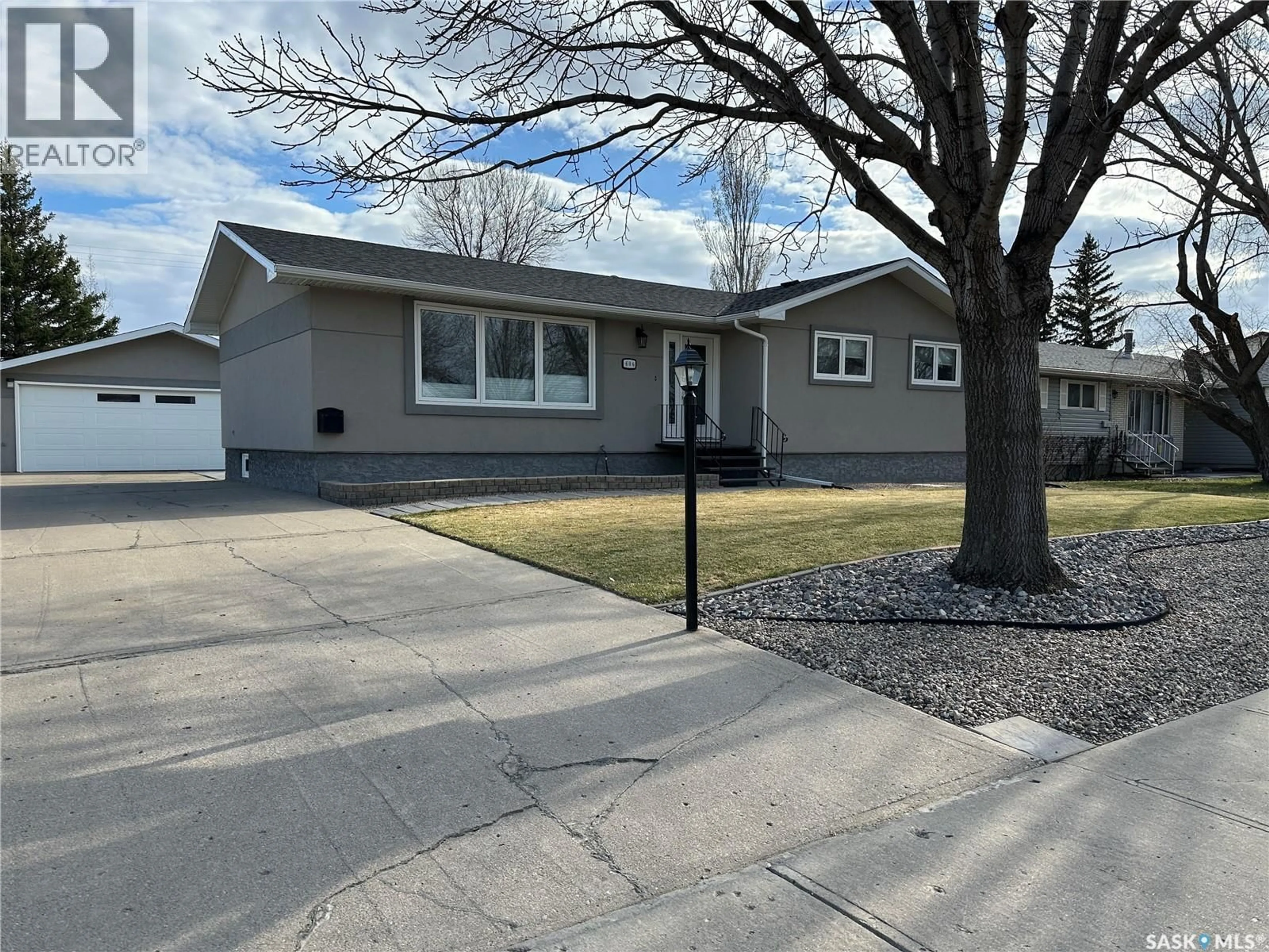 Home with vinyl exterior material, street for 606 STAVELEY CRESCENT, Weyburn Saskatchewan S4H2T6