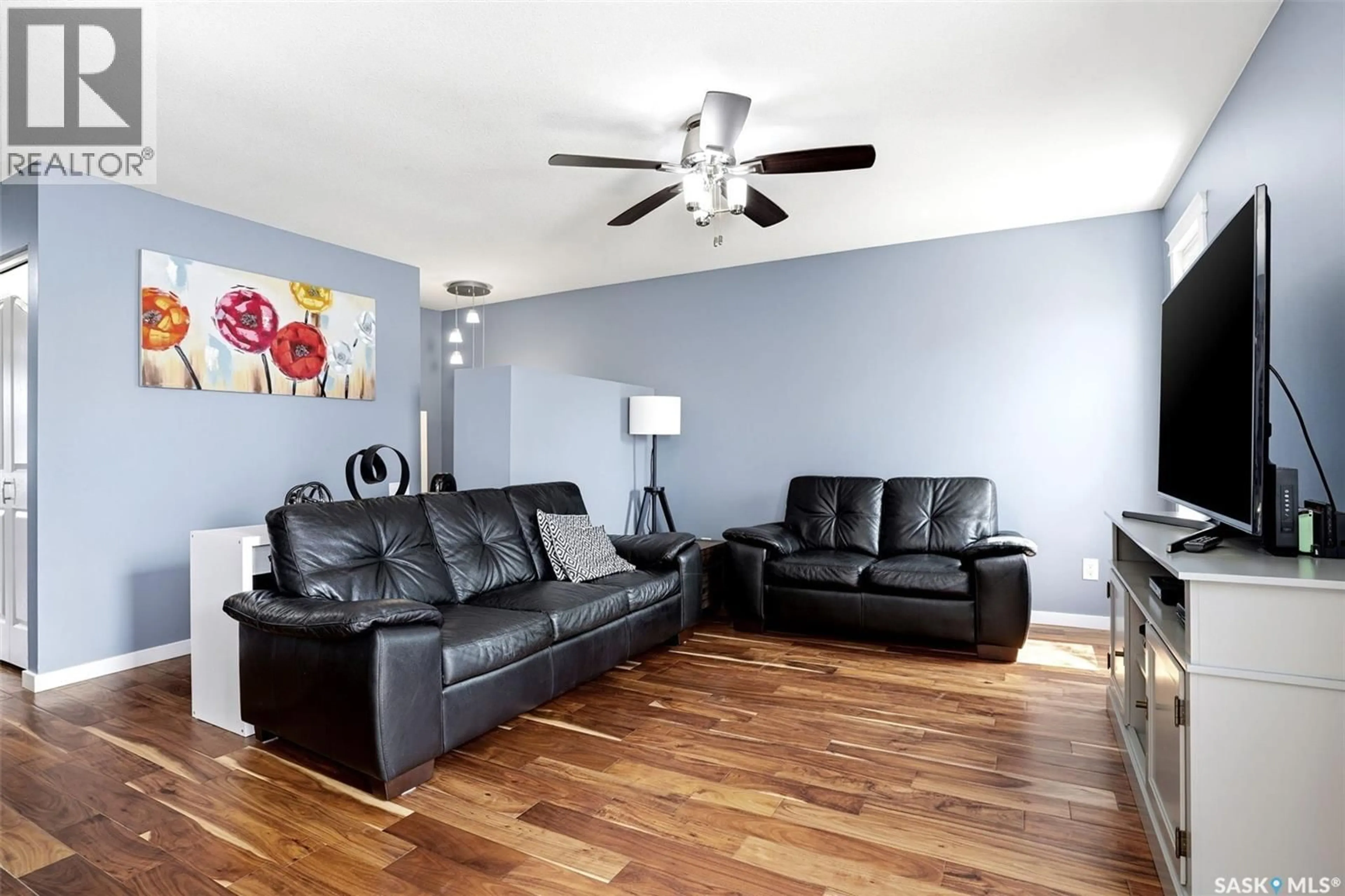 Living room with furniture, wood/laminate floor for 7203 LAWRENCE DRIVE, Regina Saskatchewan S4X3X7