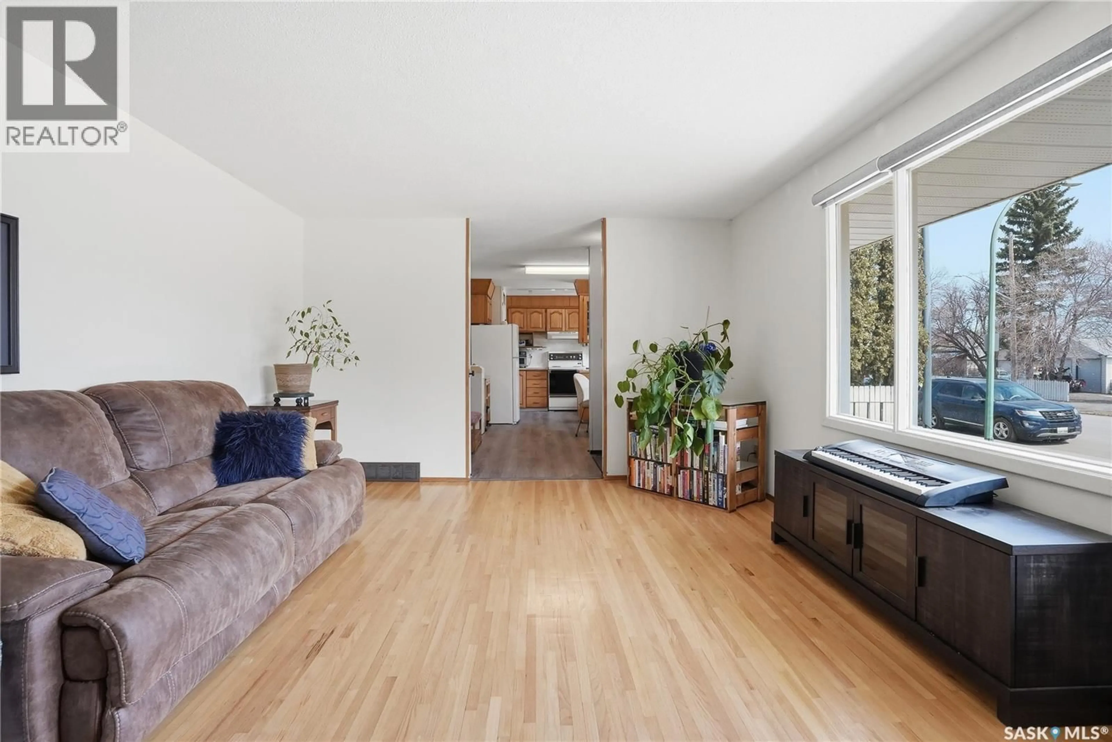 Living room with furniture, wood/laminate floor for 1117 ELEVATOR ROAD, Saskatoon Saskatchewan S7M3X1