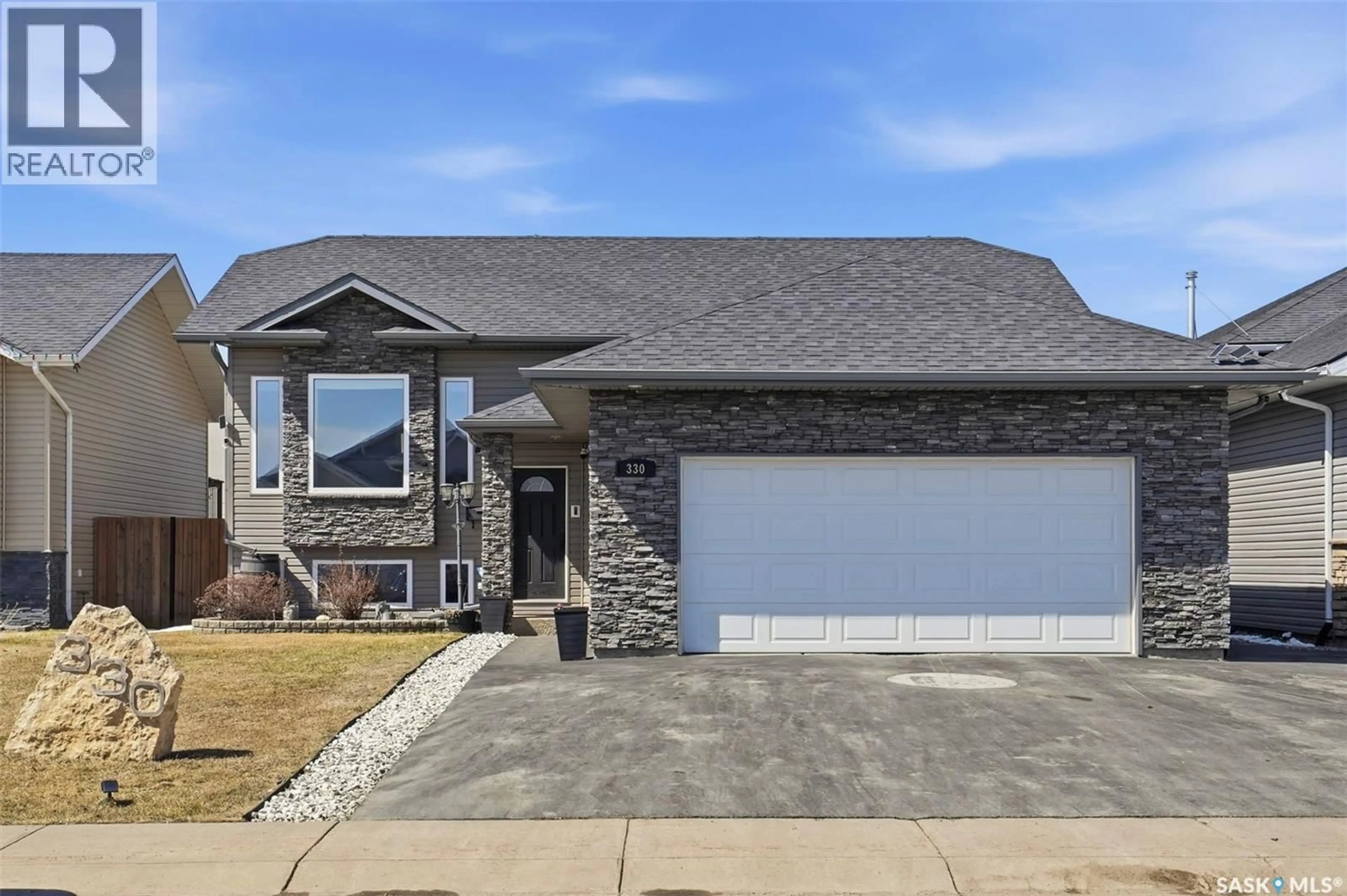 Home with brick exterior material, street for 330 PLAYER CRESCENT, Warman Saskatchewan S0K4S1