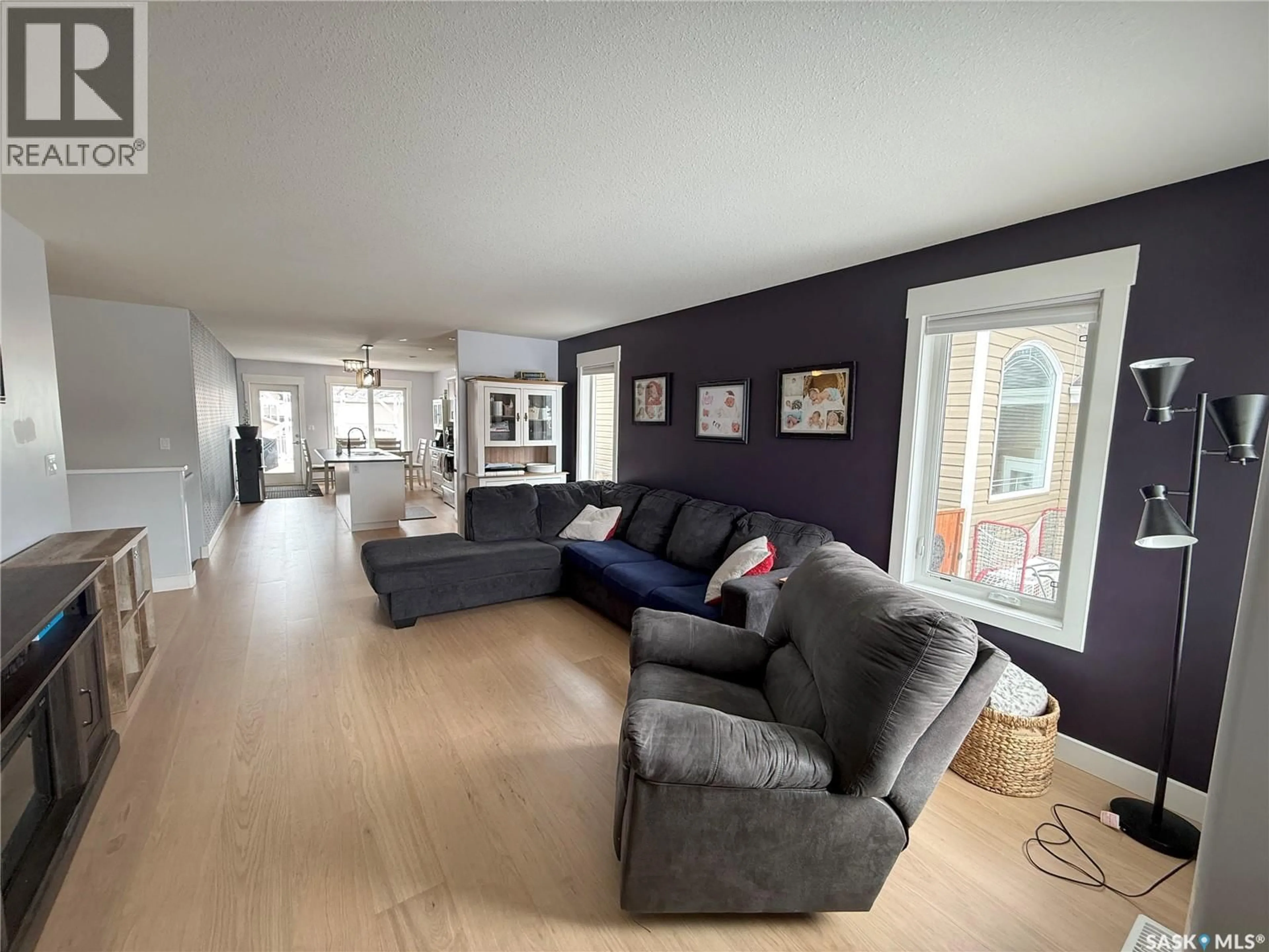 Living room with furniture, wood/laminate floor for 724 QUESSY DRIVE, Martensville Saskatchewan S0K0A2