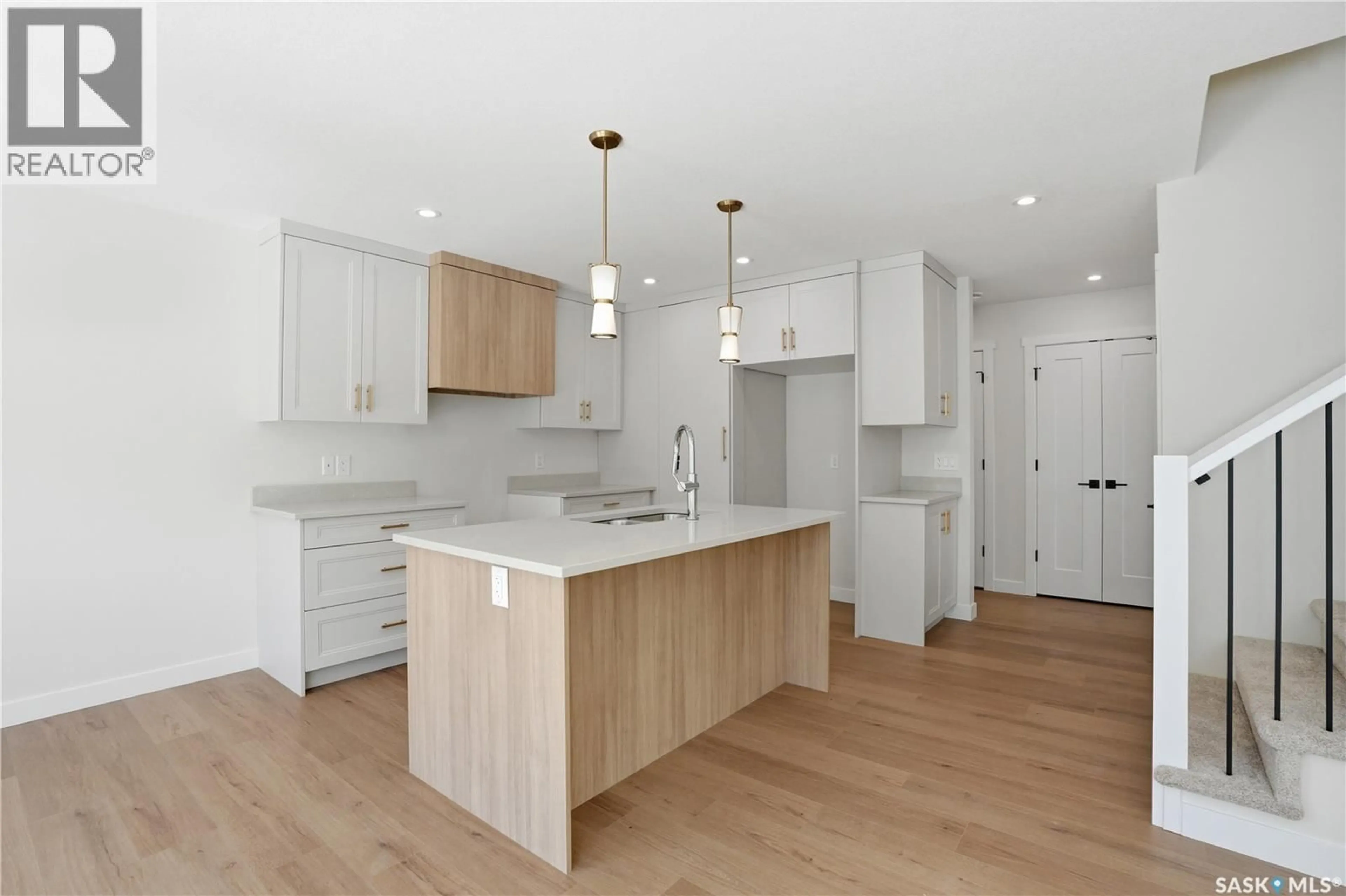 Open concept kitchen, wood/laminate floor for 311 155 MCFAULL WAY, Saskatoon Saskatchewan S7V1Z9