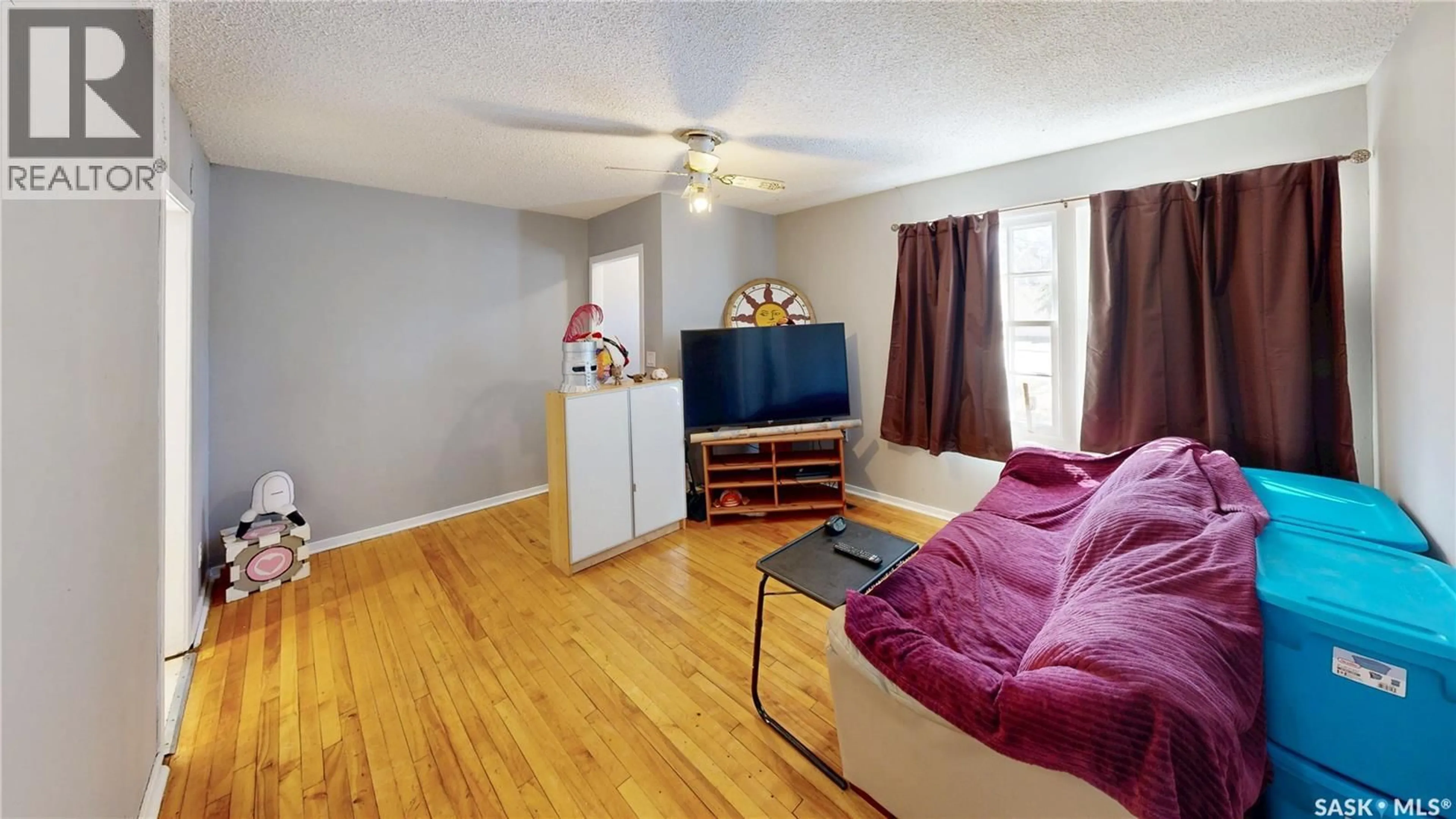 Living room with furniture, wood/laminate floor for 20 CECIL CRESCENT, Regina Saskatchewan S4T5Y5