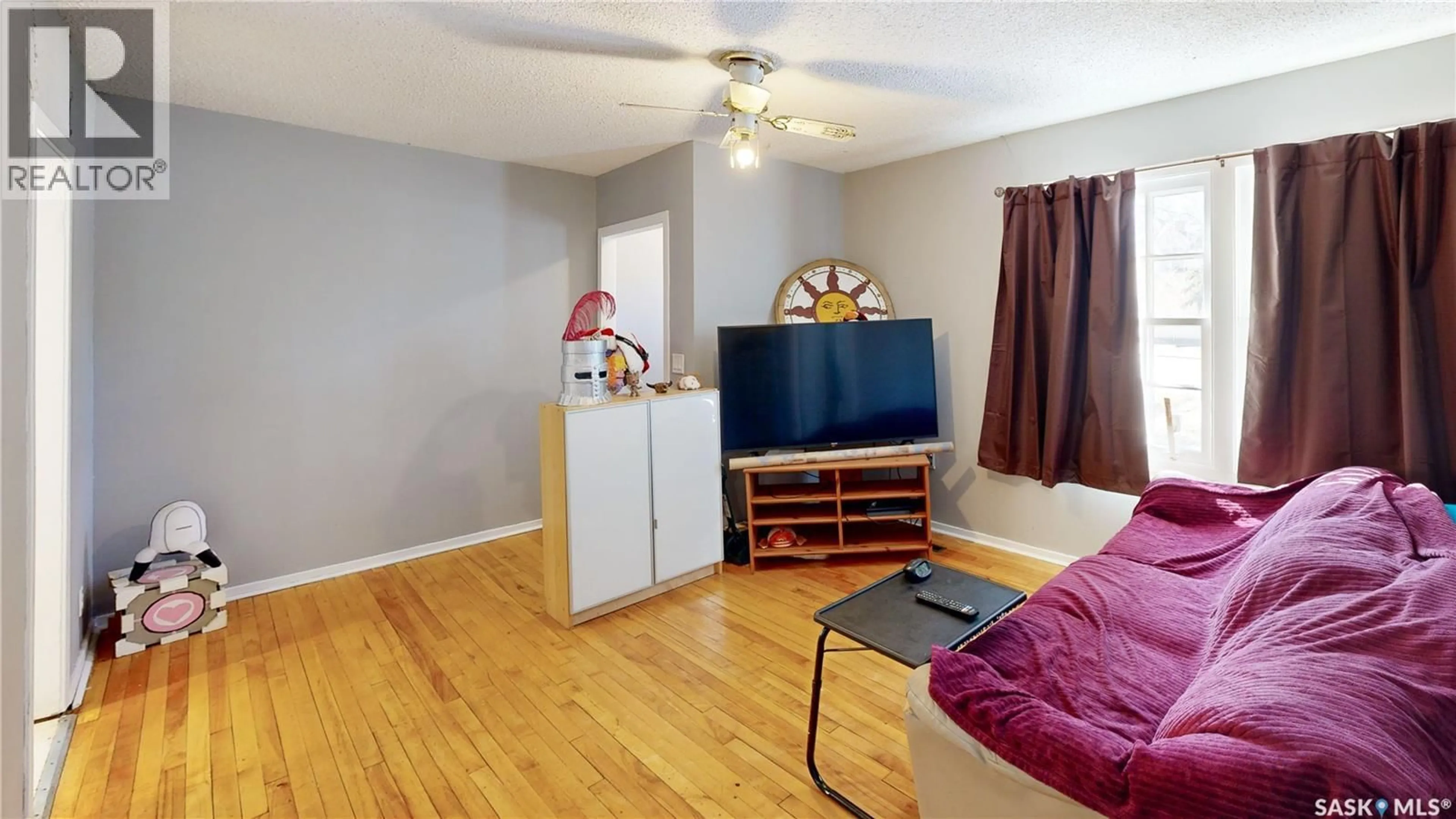 Living room with furniture, wood/laminate floor for 20 CECIL CRESCENT, Regina Saskatchewan S4T5Y5